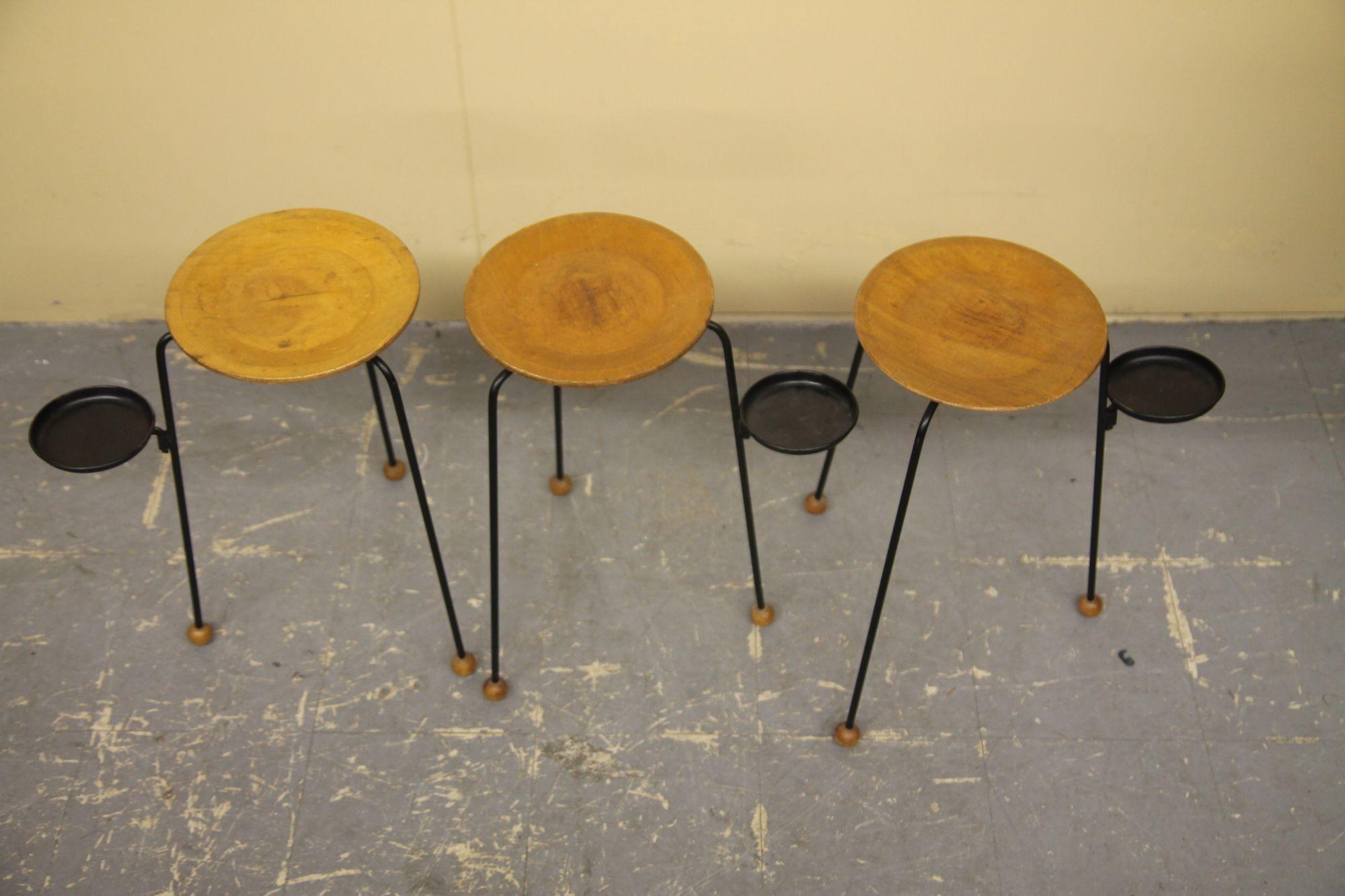 Pleased to offer these great nesting tables by Tony Paul. This design is seldom up for sale. The tables retain the metal drink holder or ash tray holder and wood ball feet These small tables are in nice vintage condition.