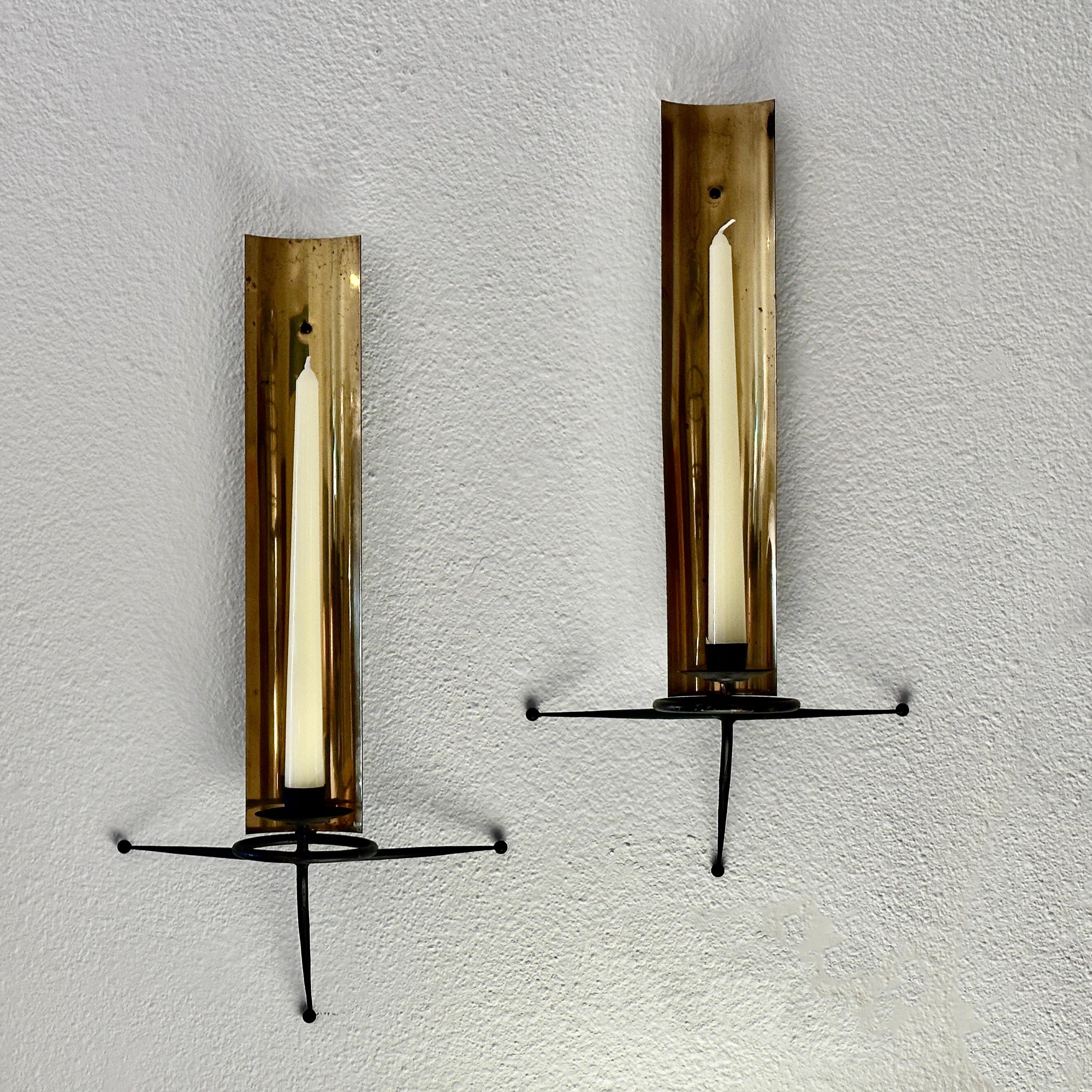 Unusual Pair of Brass and Iron Atomic Style Candle Sconces designed by Tony Paul in the 1950s.

Rare to find the pair with none of the ball wall rests damaged or missing. There is some tarnish to the brass as you can see in the detailed photos as