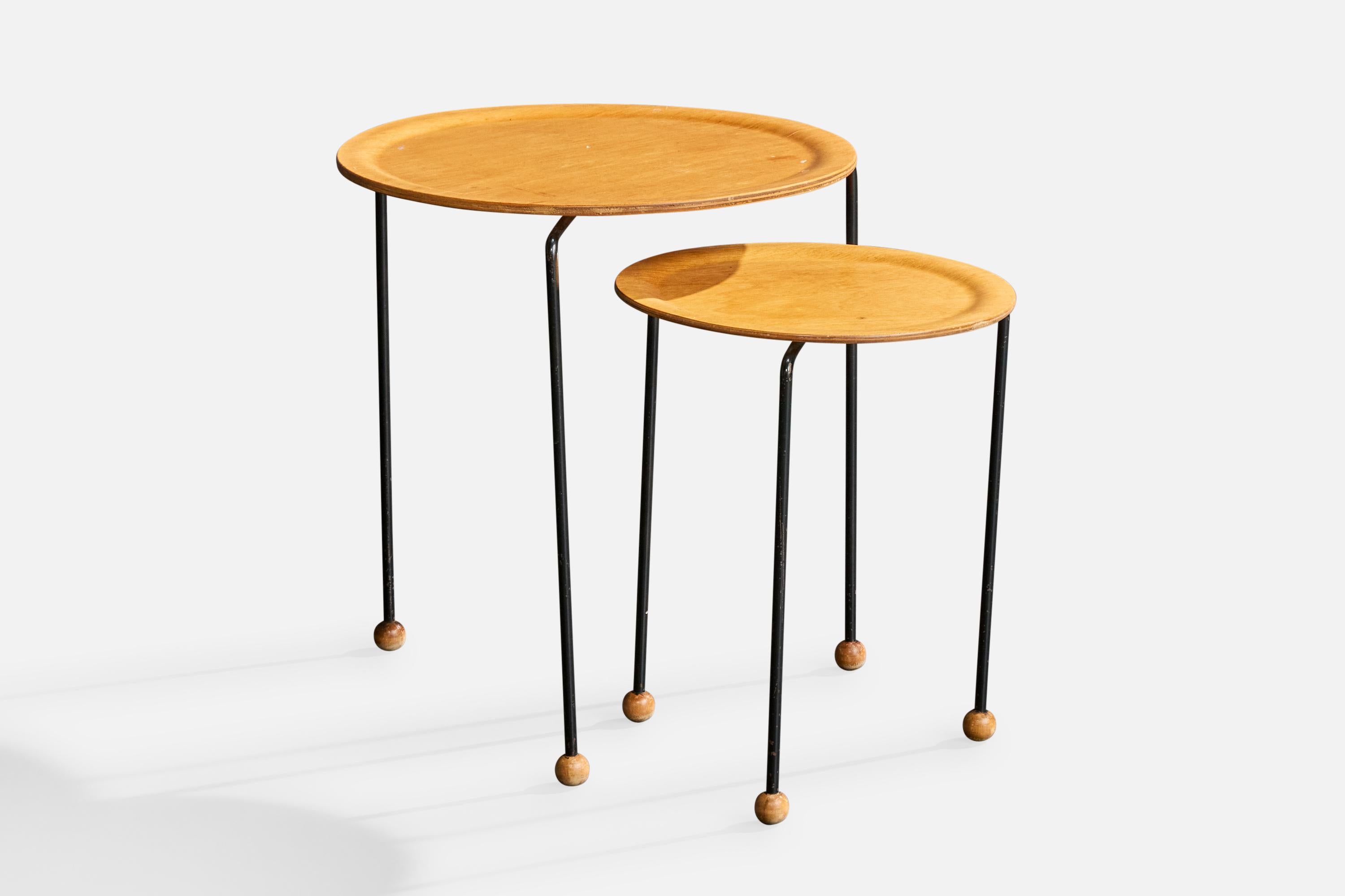 A set of two plywood and black-lacquered iron side tables designed by Tony Paul, USA, c. 1950s.

Smaller Table Dimensions (inches): 15” Height x 12.5” Diameter

Overall Dimensions (inches): 17.75