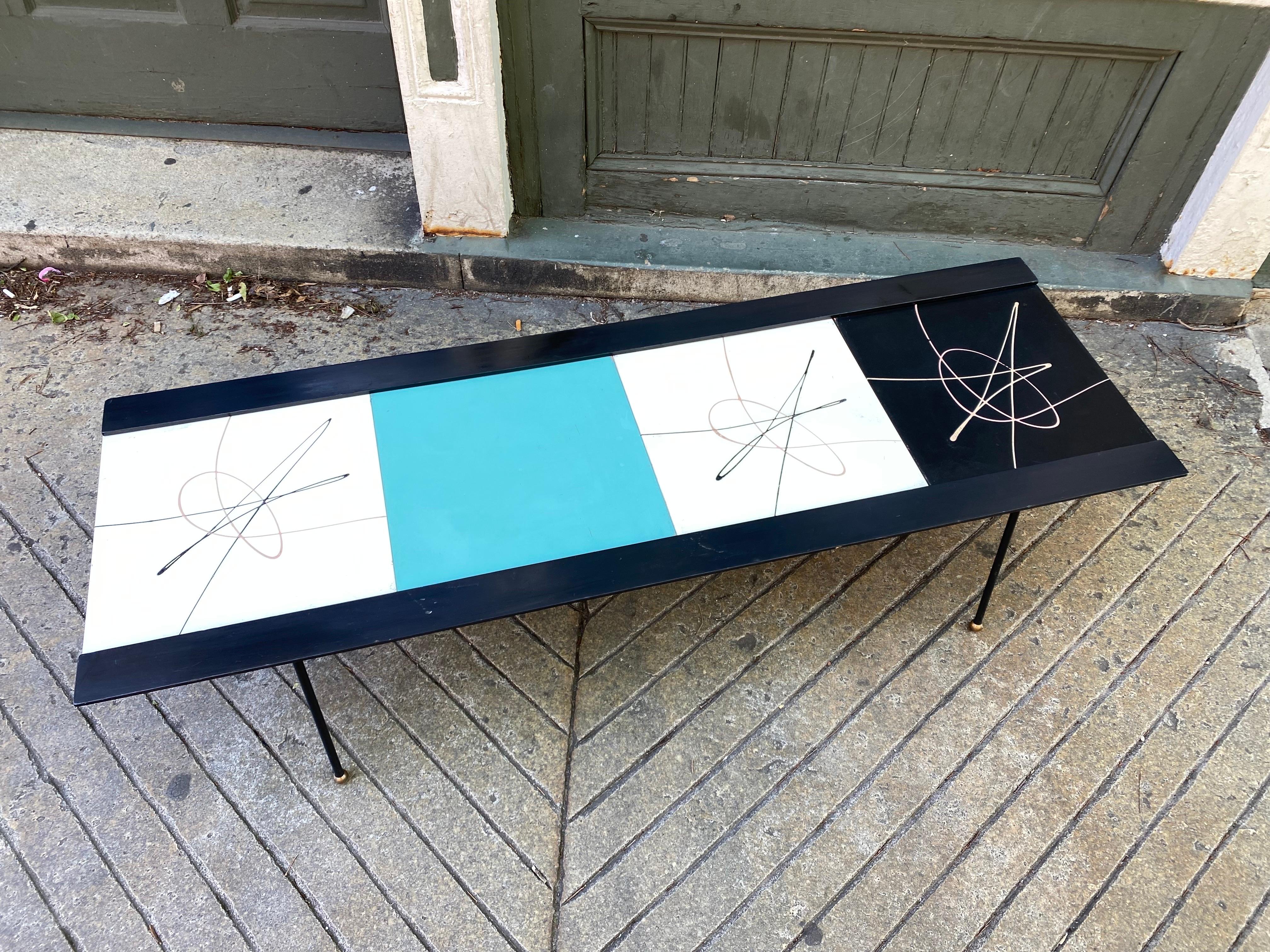 Tony Paul Style Coffee Table. Iron frame with brass ball feet. Painted Black wood sides with 4 Masonite Panels that slide into a track. Can be set up in different order by sliding out. Amazing Clean Condition! Would be easy to have a glass top cut