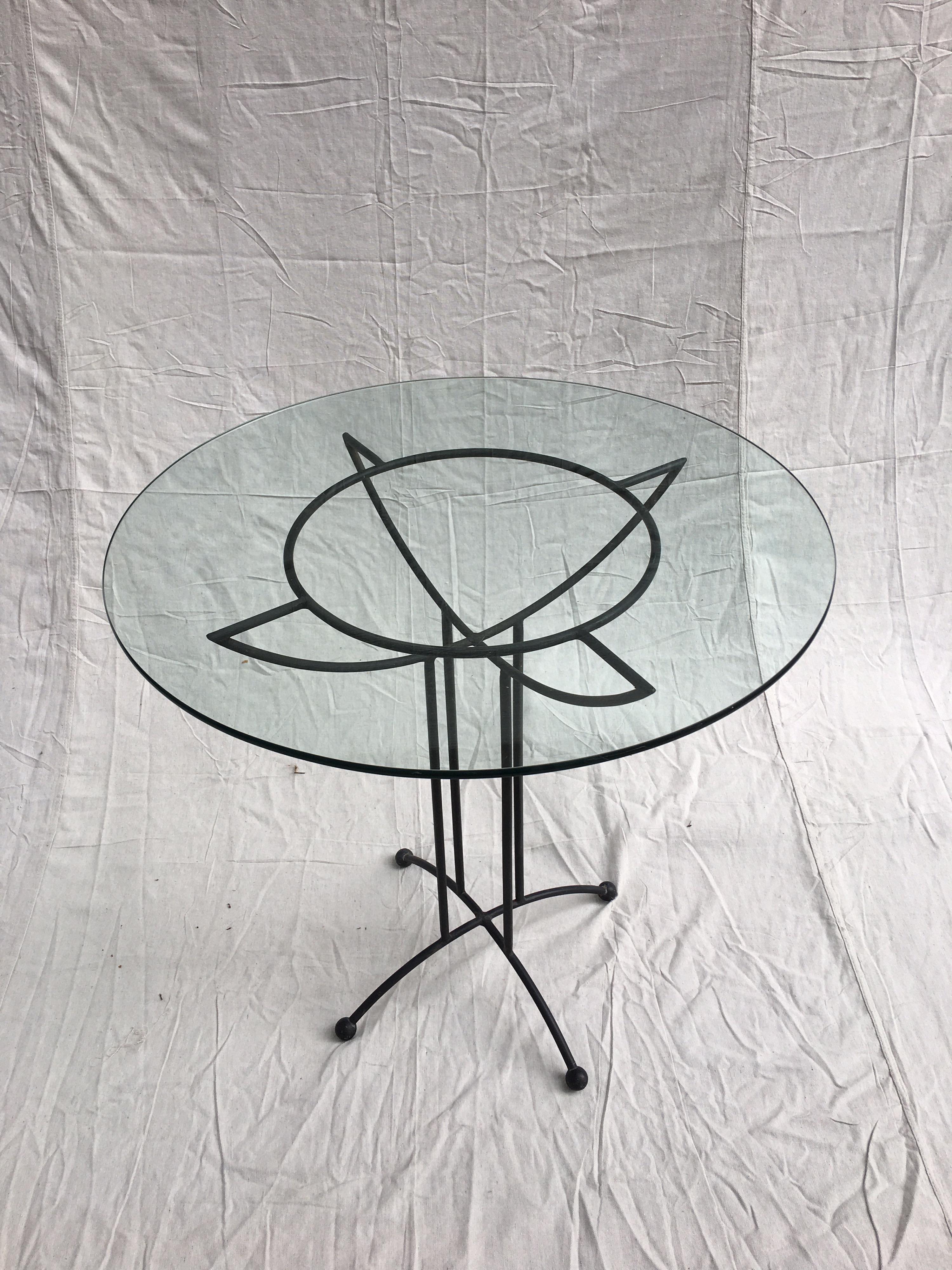 Tony Paul style glass and iron table. Great size for small spaces, use inside or out! Rubber ball feet and Geometric Design gives this table an extra kick!