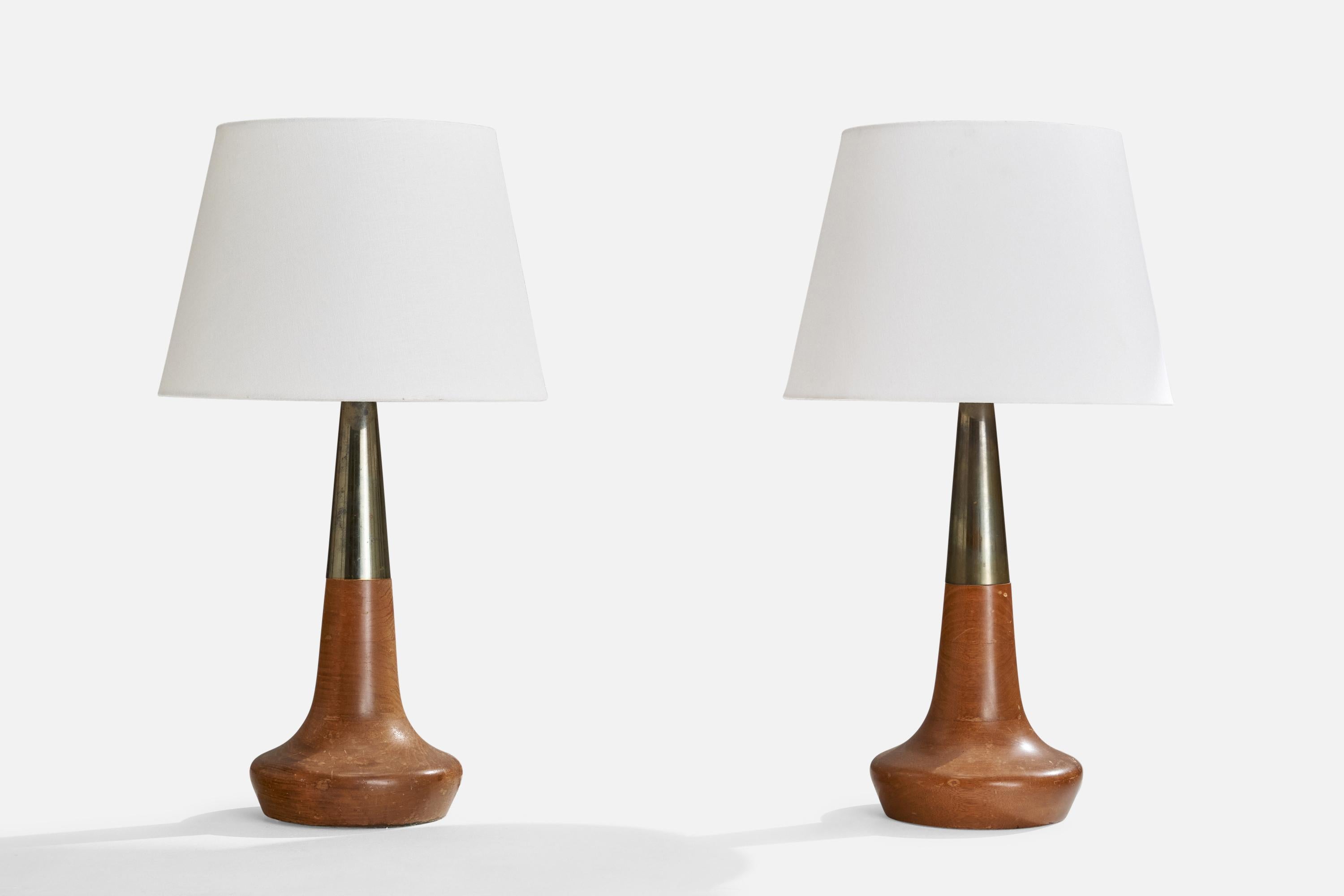 A pair of walnut and brass table lamps designed and produced in the US, c. 1950s.

With glass diffusers.

Overall Dimensions (inches): 25” H x 14” W x 15” D
Stated dimensions include shade.
Bulb Specifications: E-26 Bulb
Number of Sockets: 2
All
