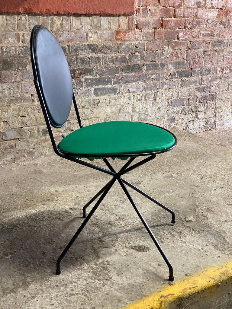 Tony Paul designed metal frame tilt back chair. Black metal frame with wire metal mesh back and upholstered in its original black vinyl and a refreshed kelly green fabric seat. Stationary seat with a tilt back for maximum comfort. Circa 1955-60. The