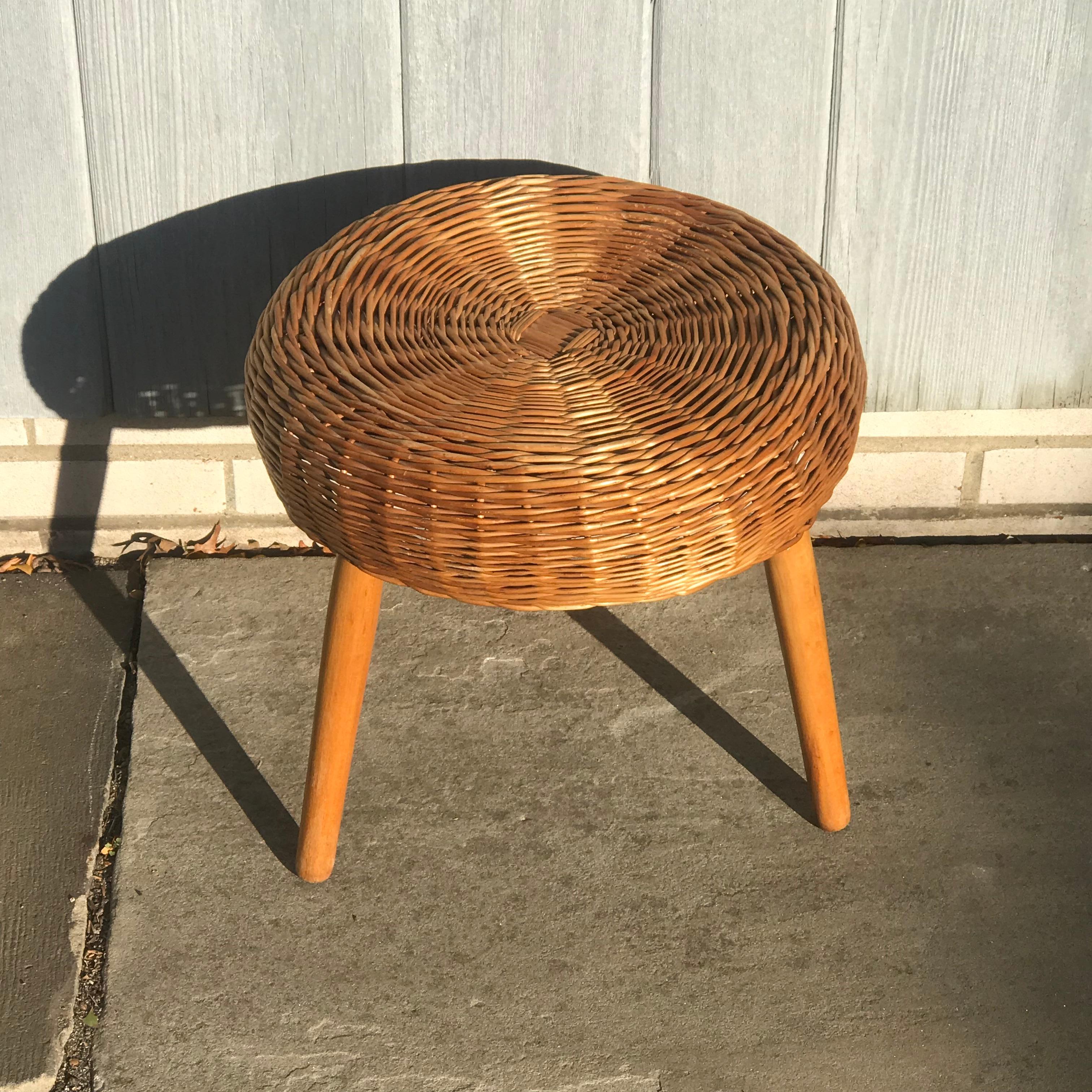 Wicker stool in the style of Tony Paul, circa 1950. Walnut wooden legs, rattan seat. In good original condition, preserving a beautiful patina.