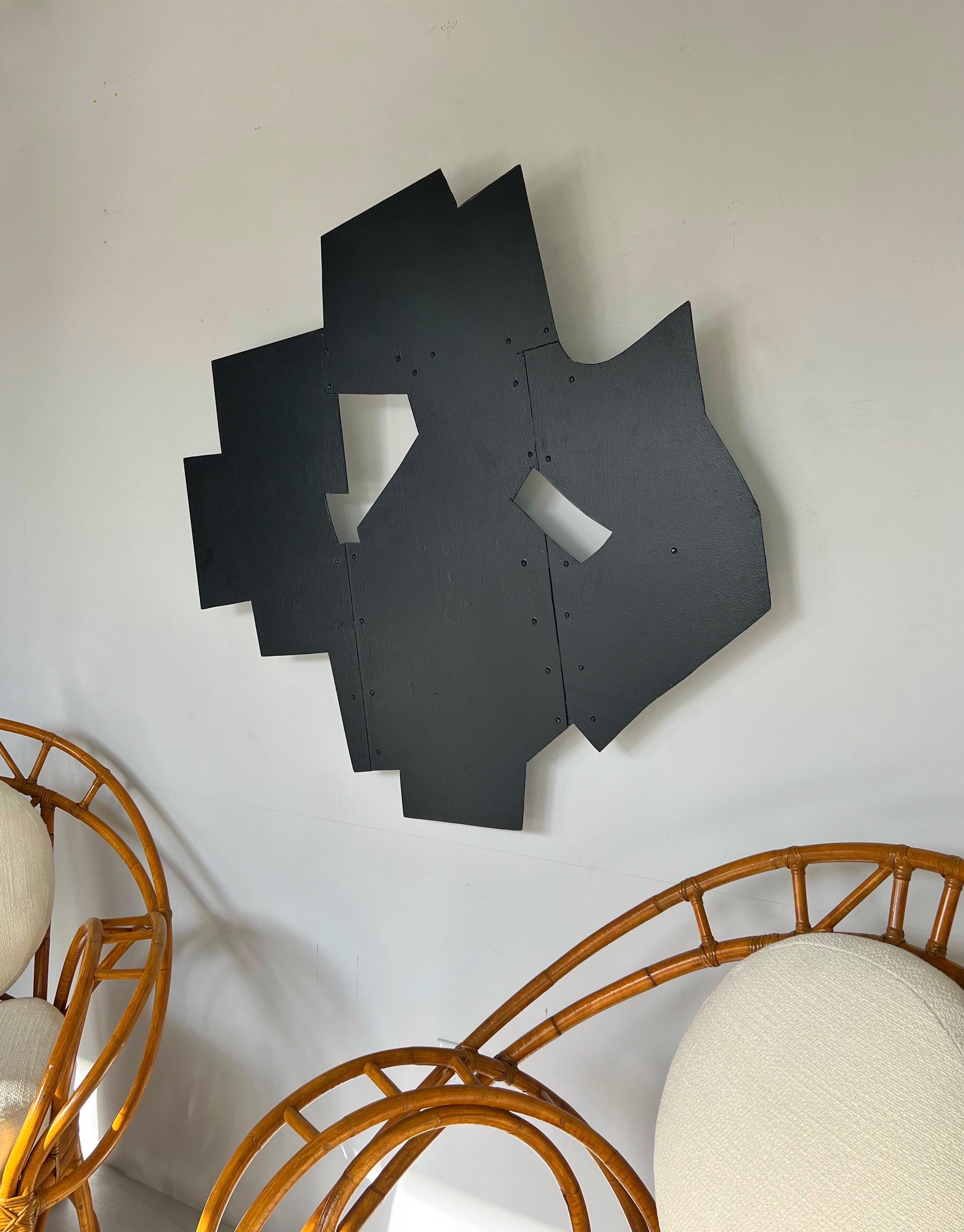 A large black wall sculpture by Tony Rosenthal. Bolted aluminum with a hand applied enamel finish on the front and white on verso. Comes with authenticity certificate from Cynthia Rosenthal. 