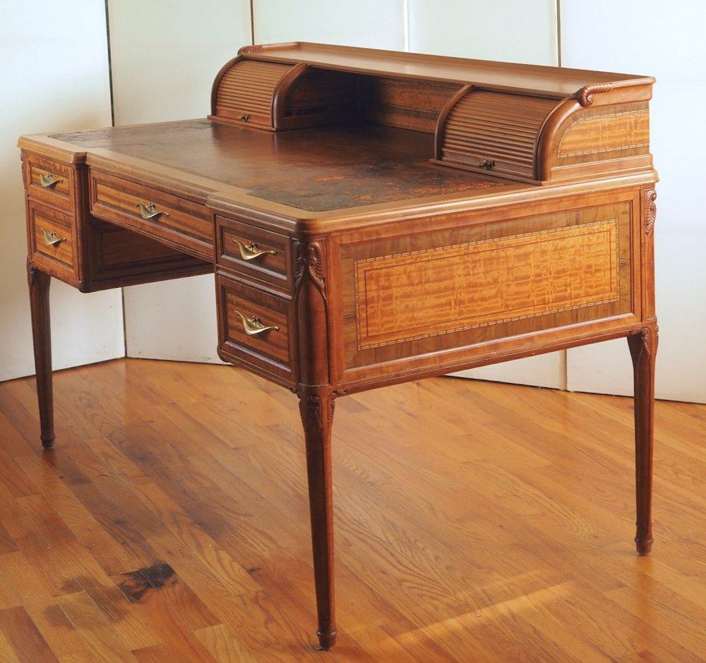 Created circa 1912,  during the transitional years between French Art Nouveau and Art Deco, this desk by Tony Selmersheim is fabricated in pearwood and satinwood, with inlays of purpleheart and other exotic hardwoods. It is 51” wide x 30” deep x 28”