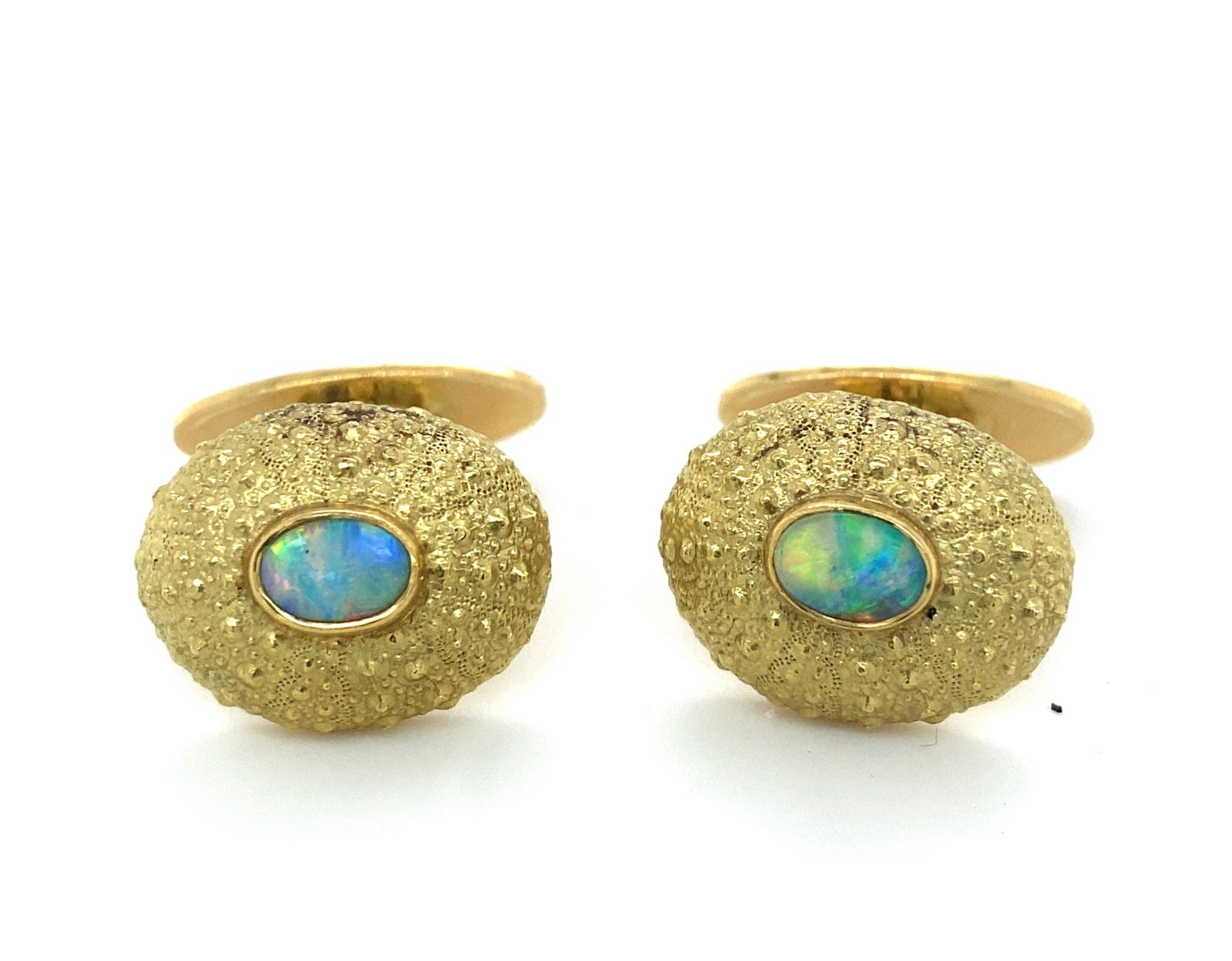 This is a stunning pair of cufflinks by Important Australian designer Tony White.  The cufflinks have a shell or sea urchin design set with high quality natural opals in 18K gold.  The cufflinks are detailed lifelike. The opals have amazing color