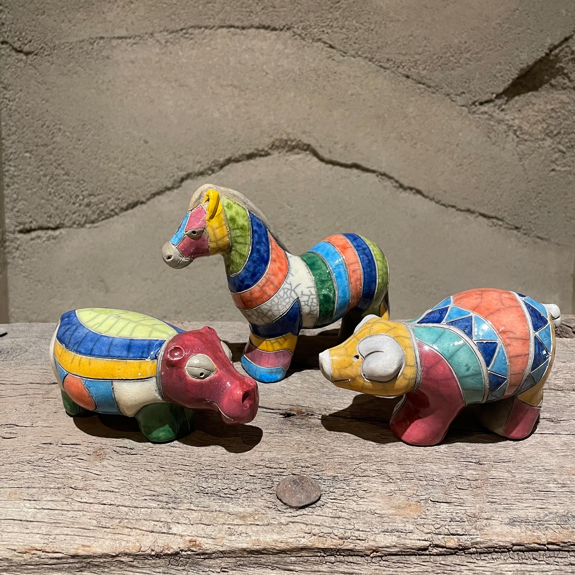 1970s Colorful Rainbow Animal Collection Set of Three
Horse 5.5H x 7D x 2.5W  Hippo 2.75H 6D x 3W   Pig 3.5T x 6L x 3W
Ceramic-pottery with a Colorful glazed finish 
Wonderful lines and patterns.
Original Vintage Preowned unrestored condition. Not