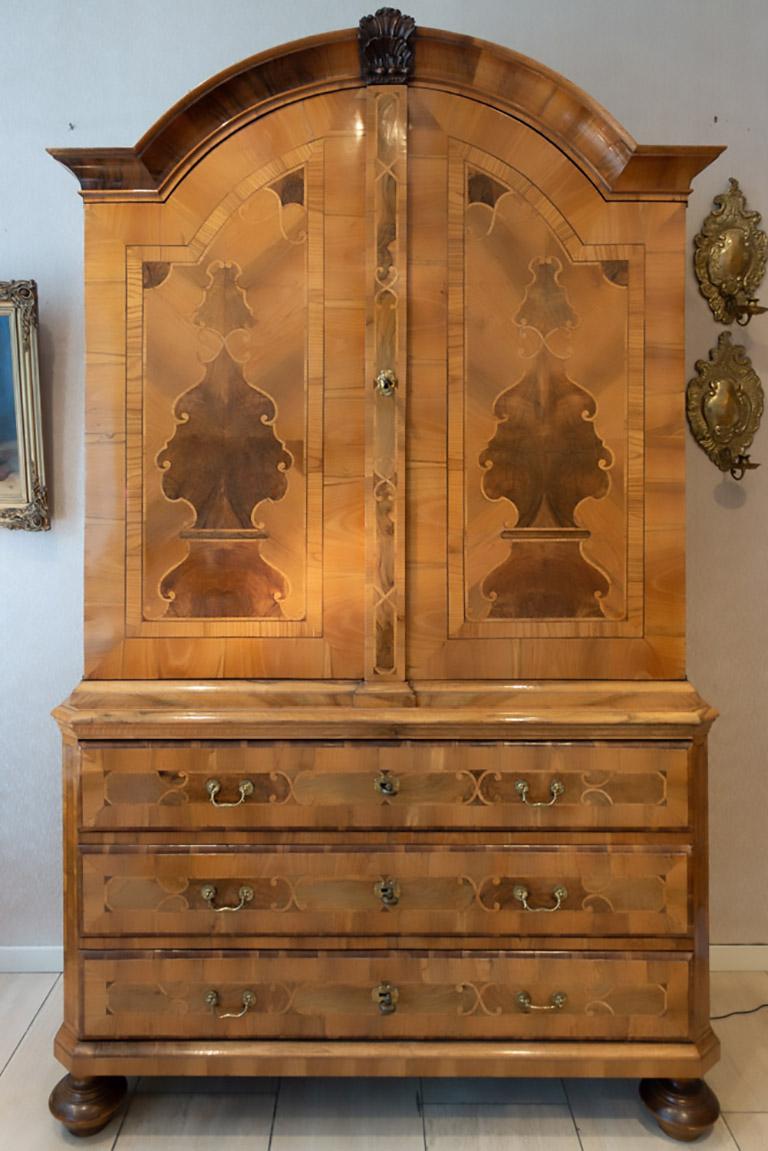 German castle furniture from the province of Anhalt with rich inlays, in small dimensions, very balanced design. 
Inlaid walnut and other woods, veneered on fruitwood. 
Original brass fittings and locks.
Inventory label backside: Castle of Mosigkau,