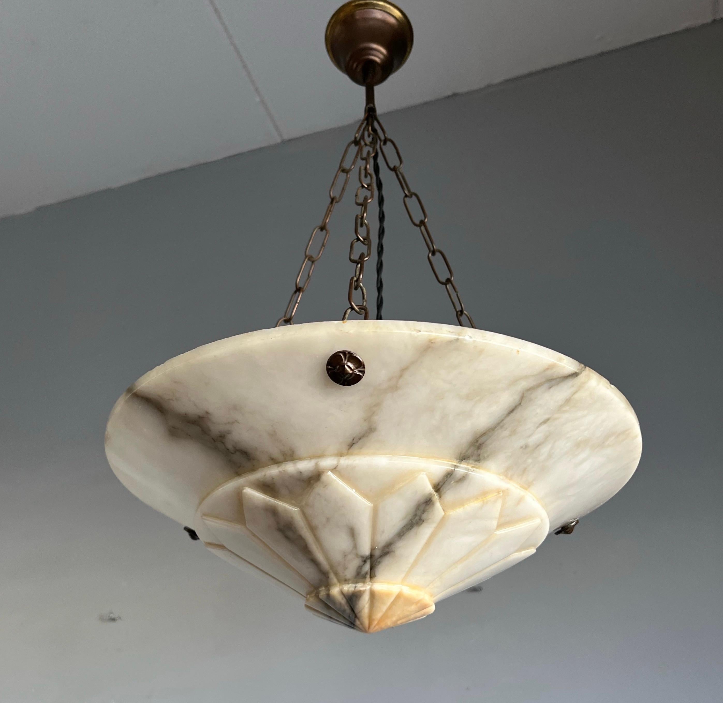 Diamant shape light fixture with a stunning hand carved alabaster shade.

With early twentieth century lighting as one of our specialties we always love finding unique antique pendants for both our trade and private clients around the globe. This