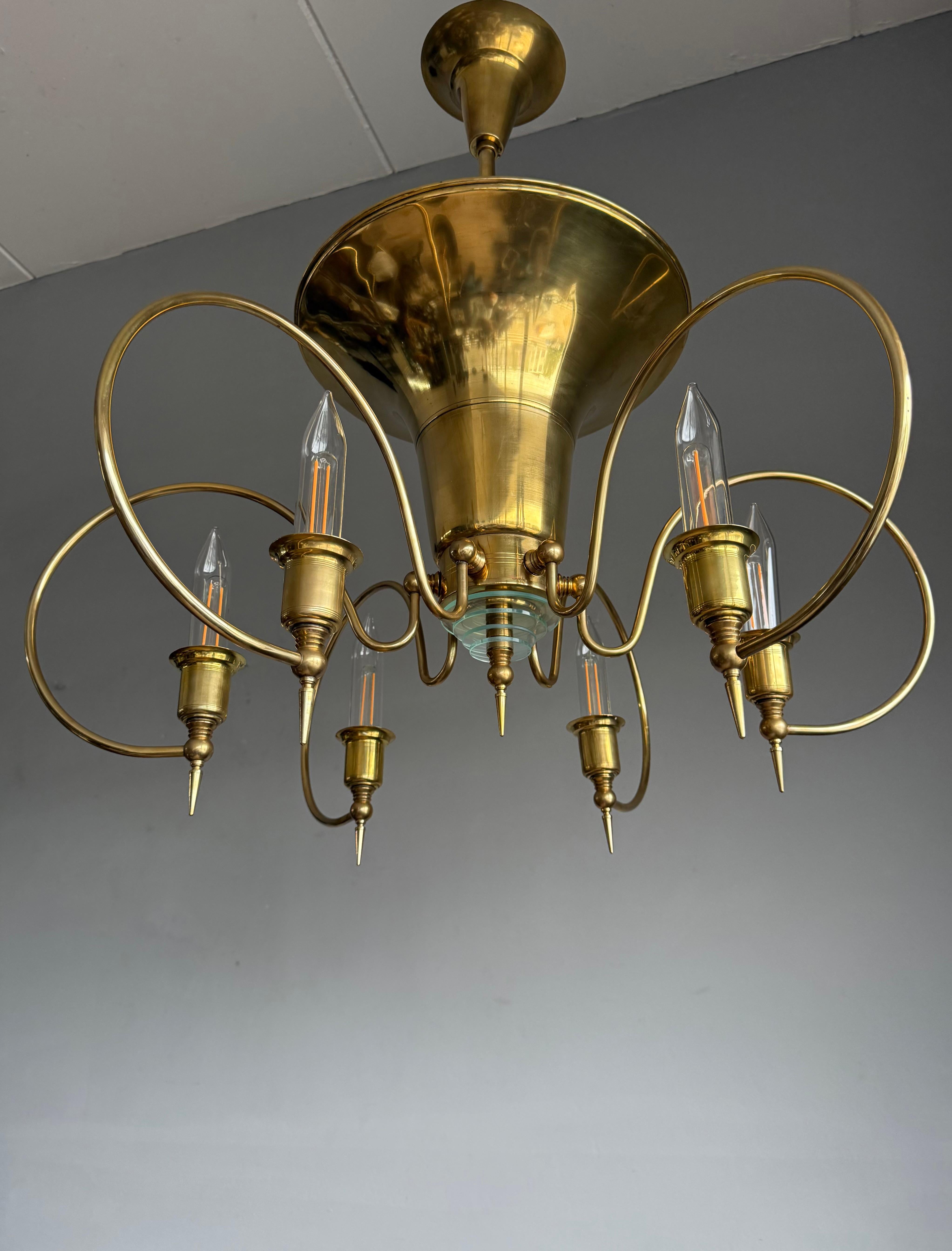 This also unique and good size, eye pleasing Art Deco Style pendant light, stands out for several reasons:

Firstly, it has a stunning brass 'body' which is in excellent condition. 
Secondly, its perfect Art Deco design makes it a true joy to own