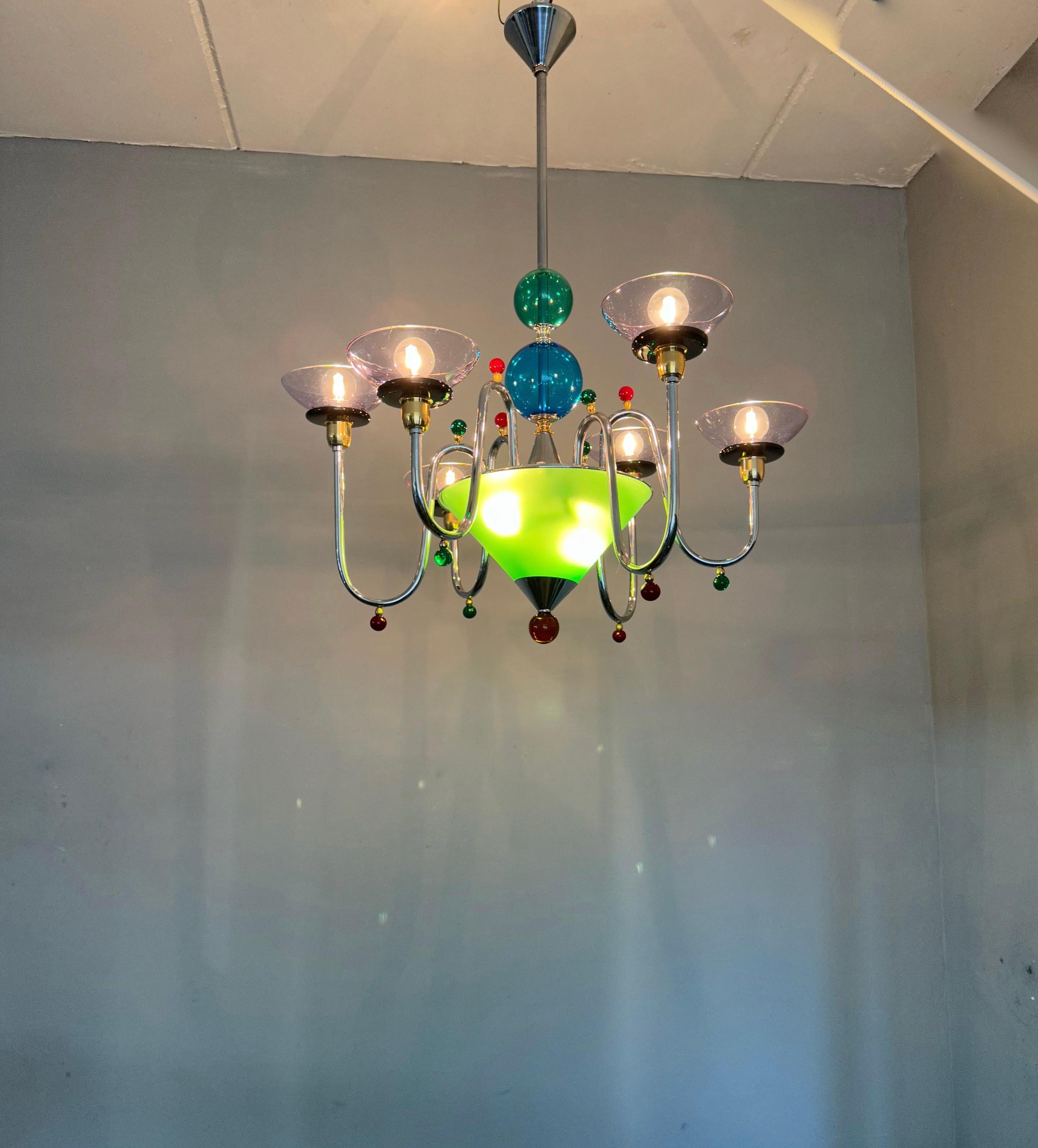 Large in size and stunning design, six arm, glass art chandelier.

This entirely handcrafted chandelier is another one of our recent statement-piece-finds. This rare and marvelous chandelier consists of six arms with marvelous and vibrant colors,