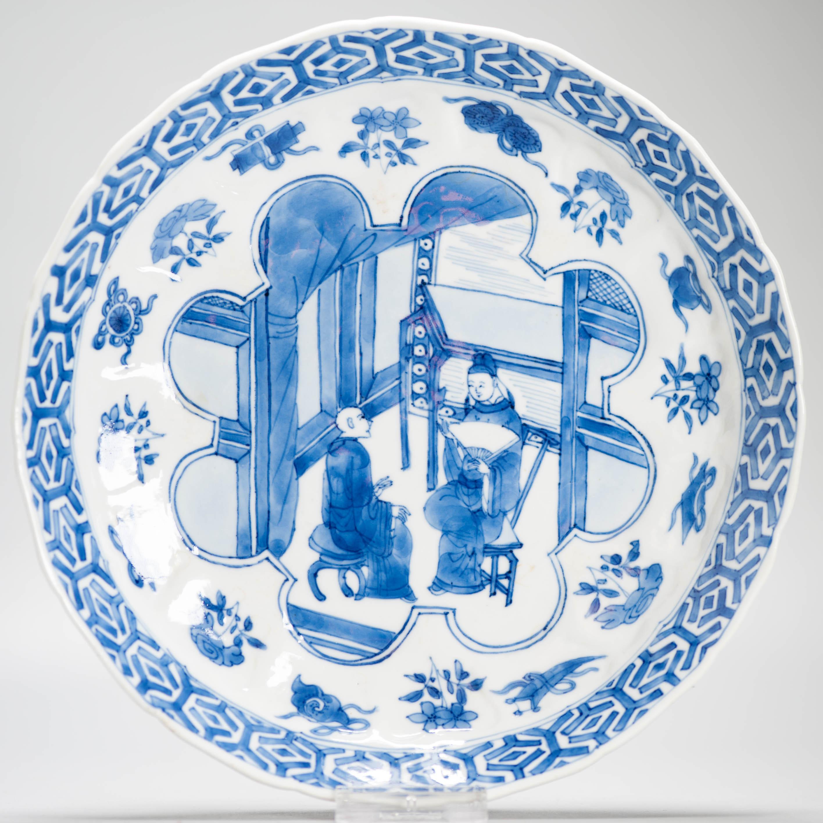 
Sharing with you this exceptionally nice Chinese porcelain Plate from the Kangxi period. It has a dark cobalt blue figural scene at the court in an unusual shaped compartment. Surrounded by flowers and objects and the wall with geometric
