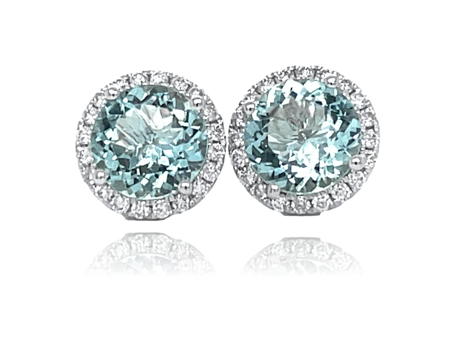 These stunning earrings have vibrant 9mm top quality Aquamarine center surrounded by sparkling brilliant cut diamonds. These earrings come in a beautiful black box for the perfect gift. They have detailed tags and are brand new. 

14KW gold:  2.85