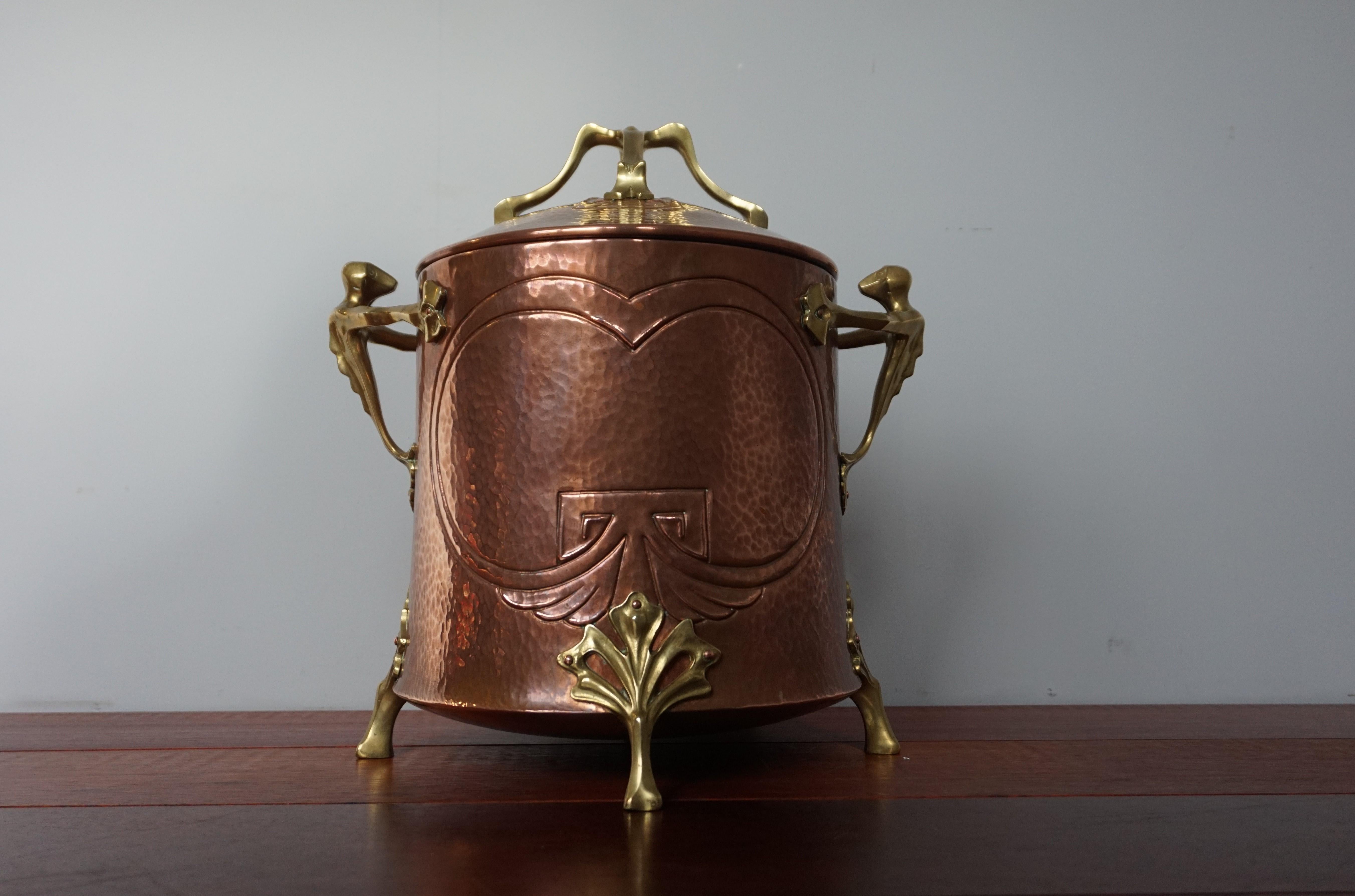 Unique and top quality workmanship, Arts & Crafts bucket.

If this unique Arts & Crafts bucket did not have the bronze sculptures and handle on top then we would have been quite certain that this bucket was created by WMF. These famous German