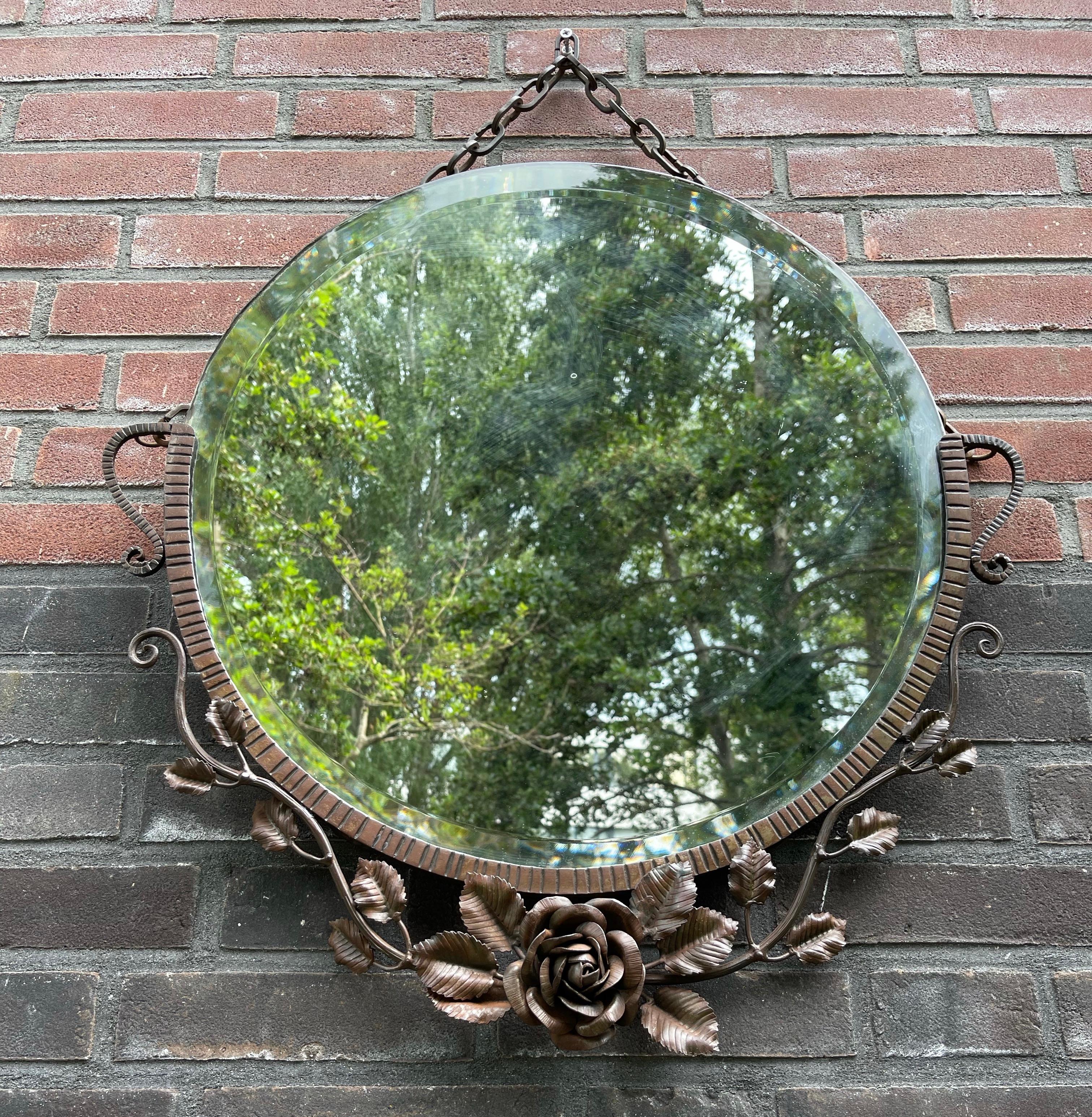 Rare and stunning Art Deco mirror with a handforged Rose flower and leafs.

This handcrafted antique mirror is another great example of the quality and decorative beauty that European craftsman were creating in the earliest years of the twentieth