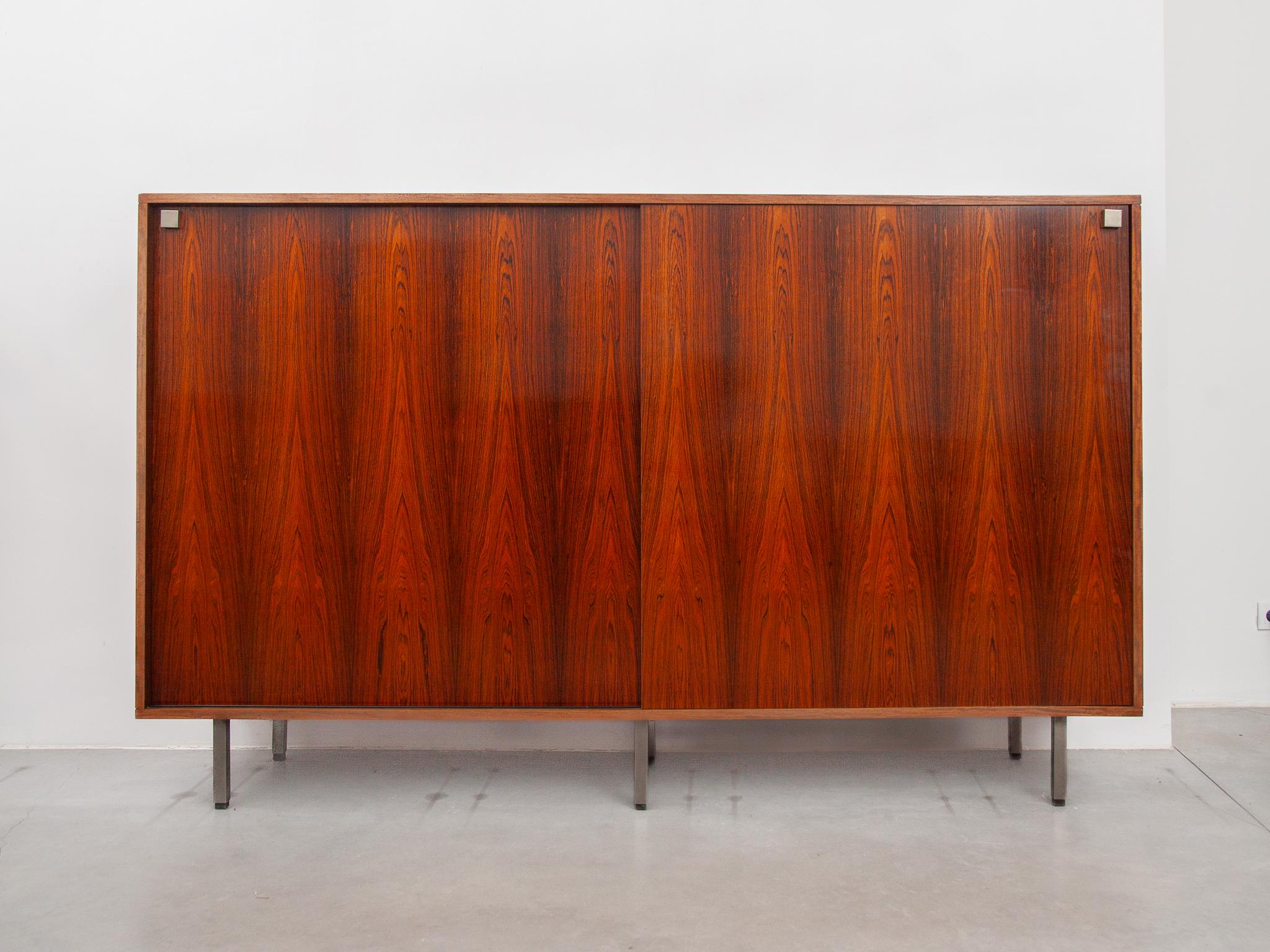 Large high sideboard designed by Alfred Hendrickx for Belform with 2 sliding doors. Sideboard made of a beautiful accent in bubinga wood with inside a compartment made of white and black laminate that can be used as a bar or desk a sideboard for