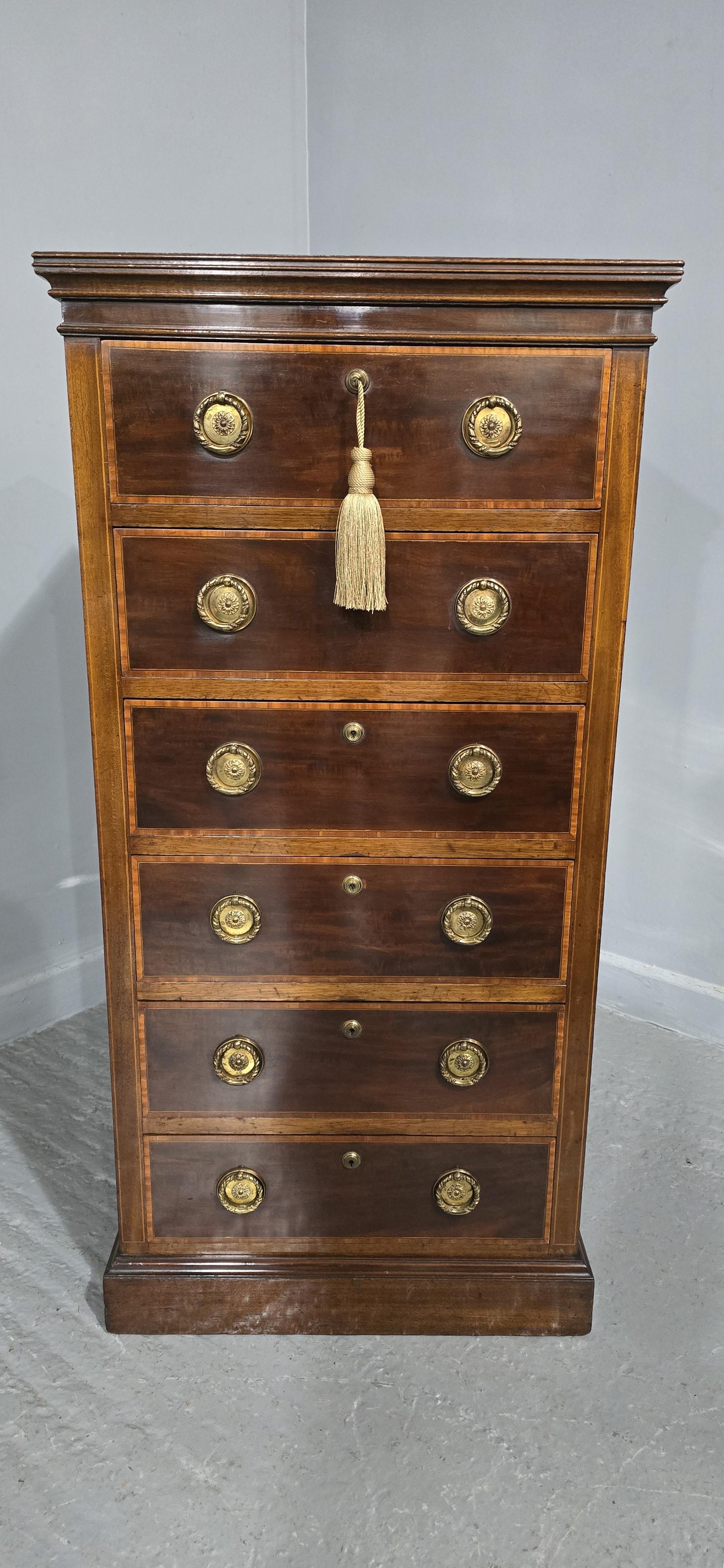 Tall mahogany chest of six inlaid drawers with brahma locks,  'Maples' badge brass ring handles, in excellent original condition.

42.5
