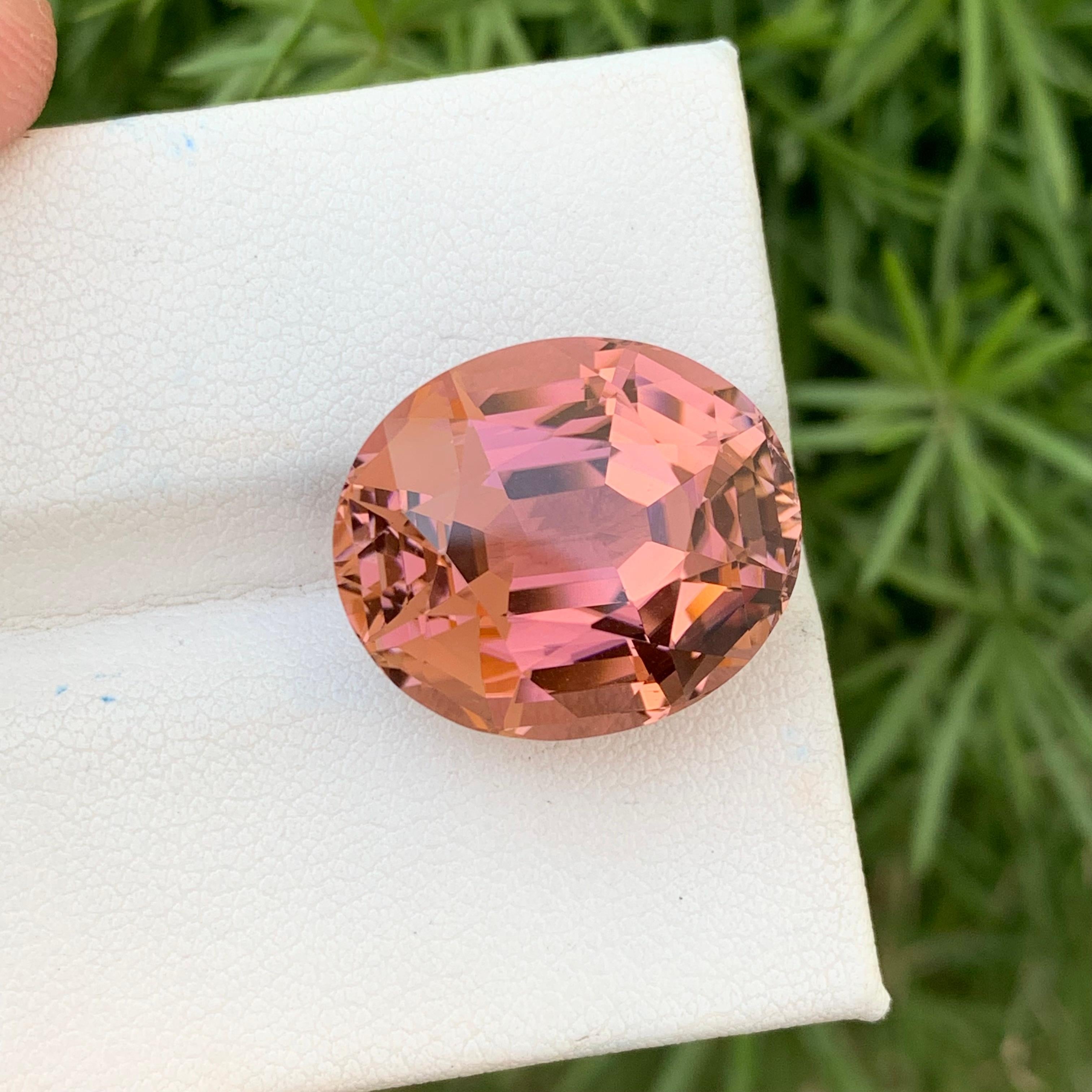 Loose Tourmaline 
Weight: 21.40 Carats 
Dimension: 18.7x15.9x11.4 Mm
Origin: Kunar Afghanistan 
Shape: Oval
Treatment: Non
Color: Peach
Certificate: On Demand
Peach Tourmaline, a gemstone bathed in warm hues reminiscent of a delicate sunrise,
