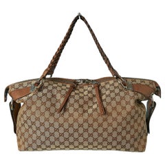 Top shoulder bag in canevas monogram pattern and leather top handle Gucci