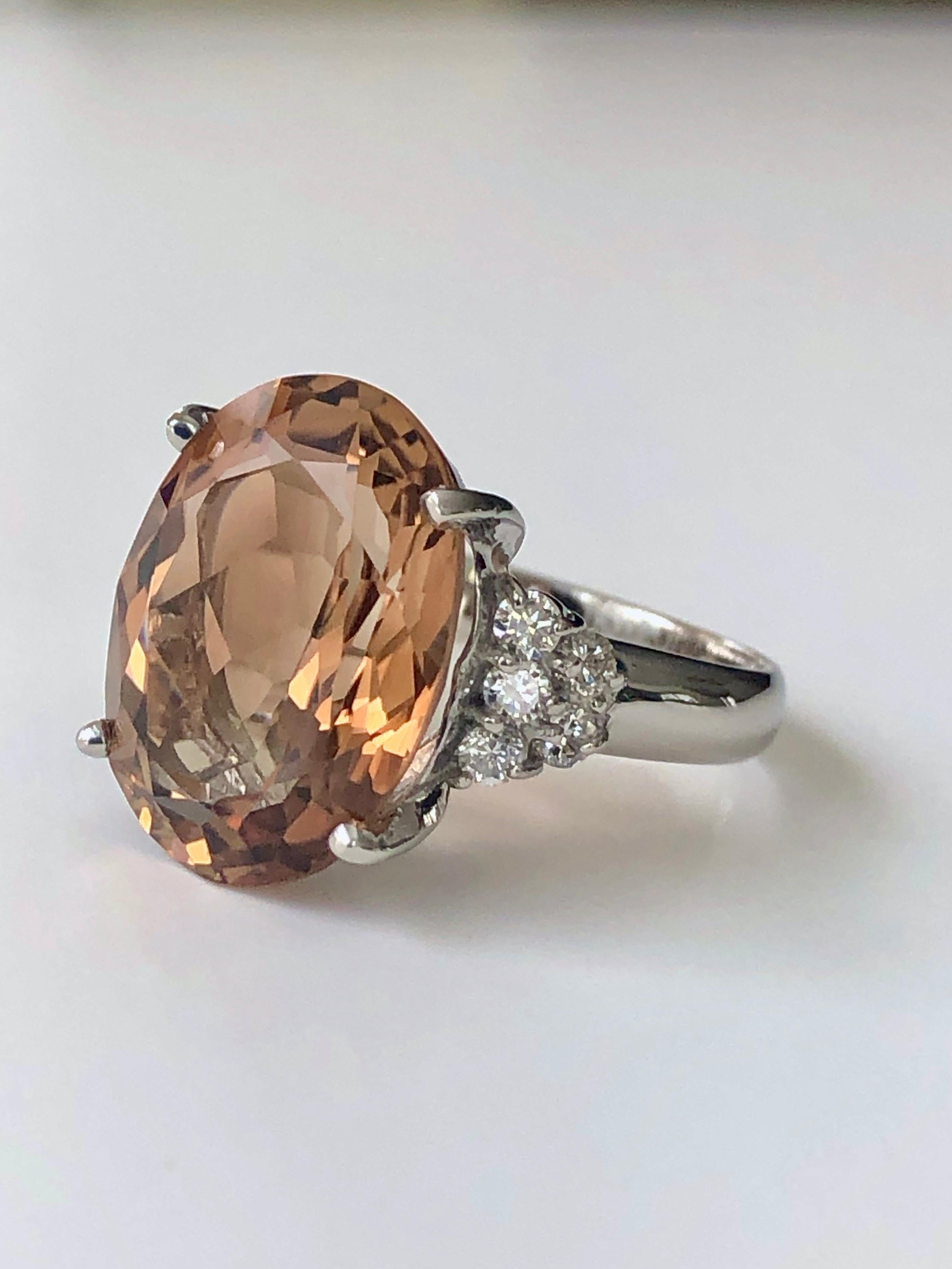 Estate sparkling classic cocktail natural brownish orangish Imperial topaz and diamond ring platinum 900
Main stone: Untreated Natural Topaz Oval Cut 10.46 carat
Side stone: Diamond 0.32 carat G, SI2
Total Gemstone; 10.78 Carats
Size: 6.75
Weight: