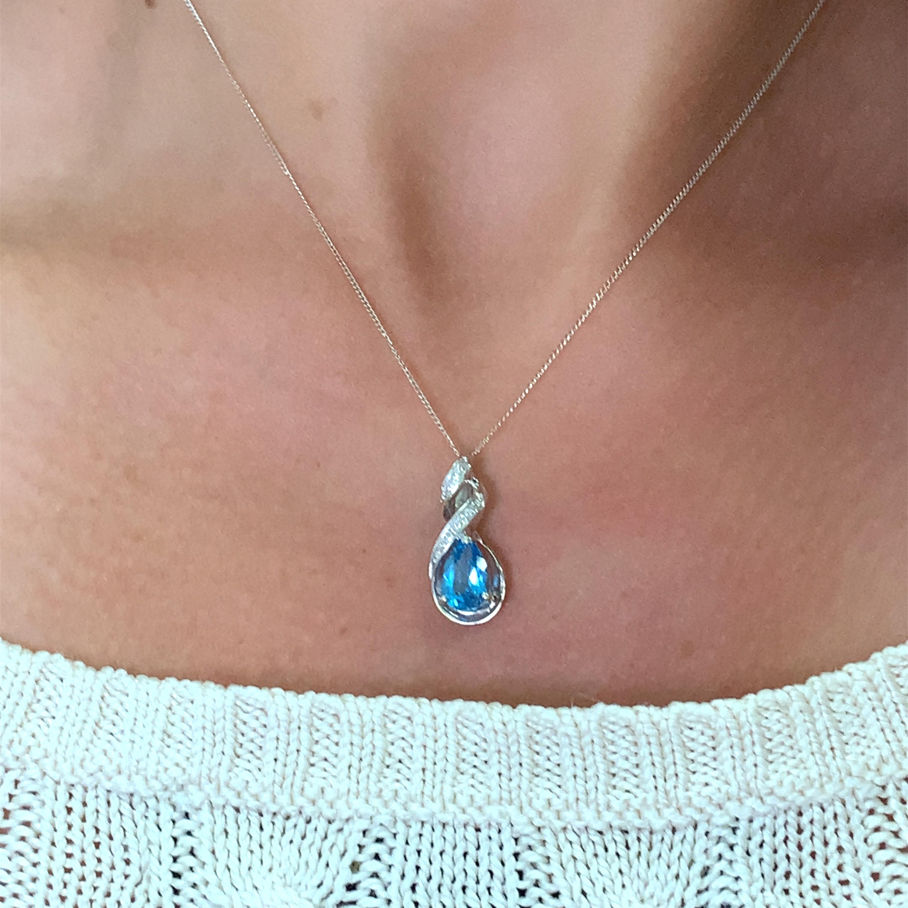 This stunning necklace is the perfect accessory to add a touch of elegance to any outfit. The beautiful pear-shaped pendant features 1.50ct topaz and diamonds in halo setting, giving it a unique and eye-catching appearance. The necklace is made of
