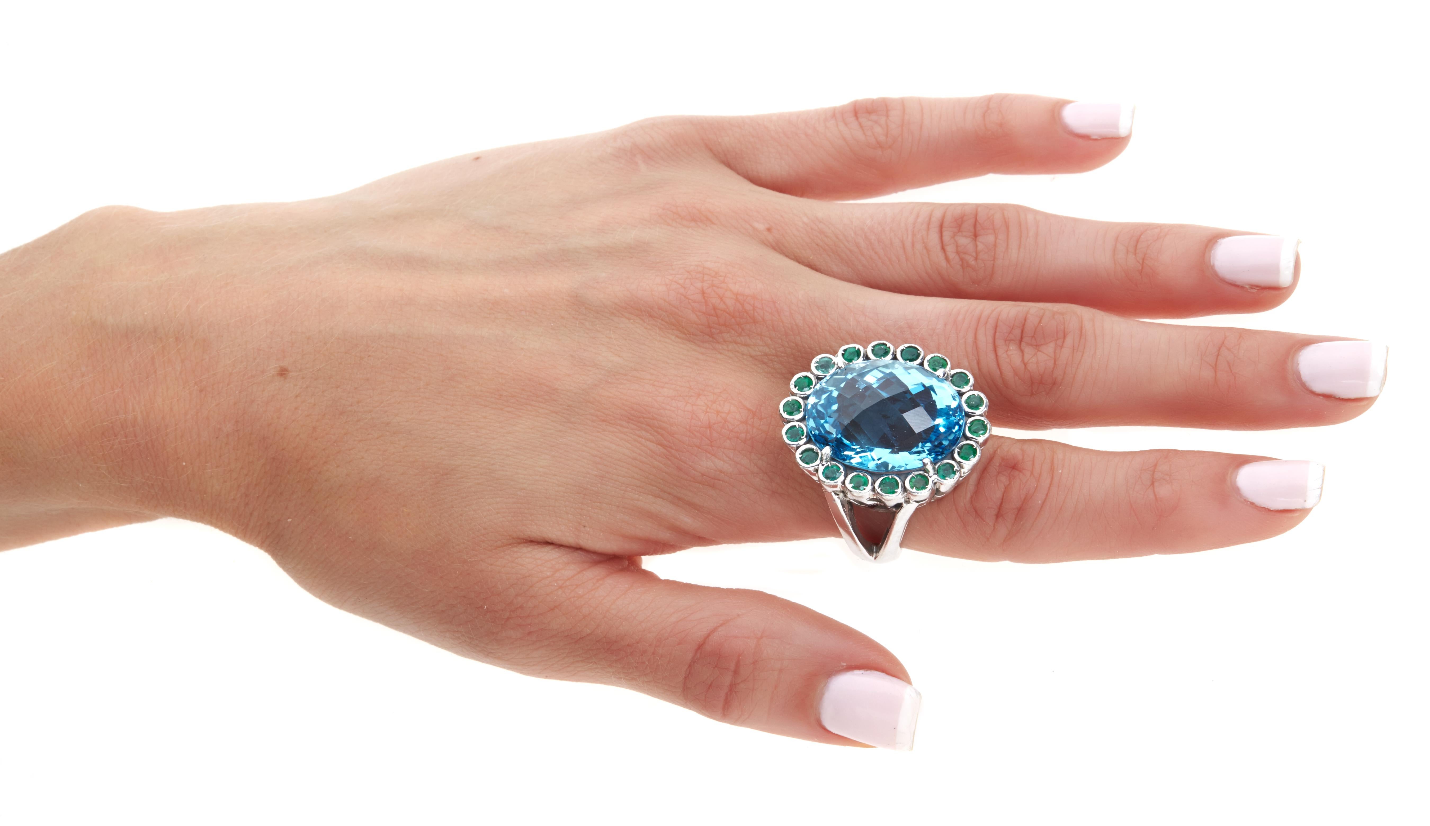Sabrina Balsky Jewelry
One of a Kind 33.50 Sparkling London Blue Topaz Cocktail Ring surrounded by Bezel set Columbian Emeralds in signature design in Rhodium Plated Sterling 1-3/16