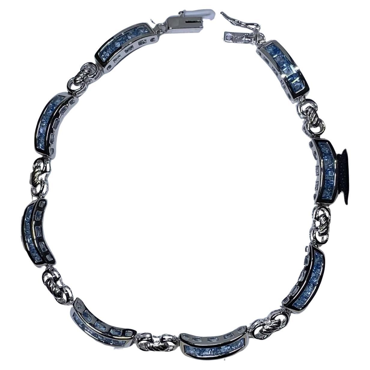 Topaz blue tennis bracelet in 10K white gold.