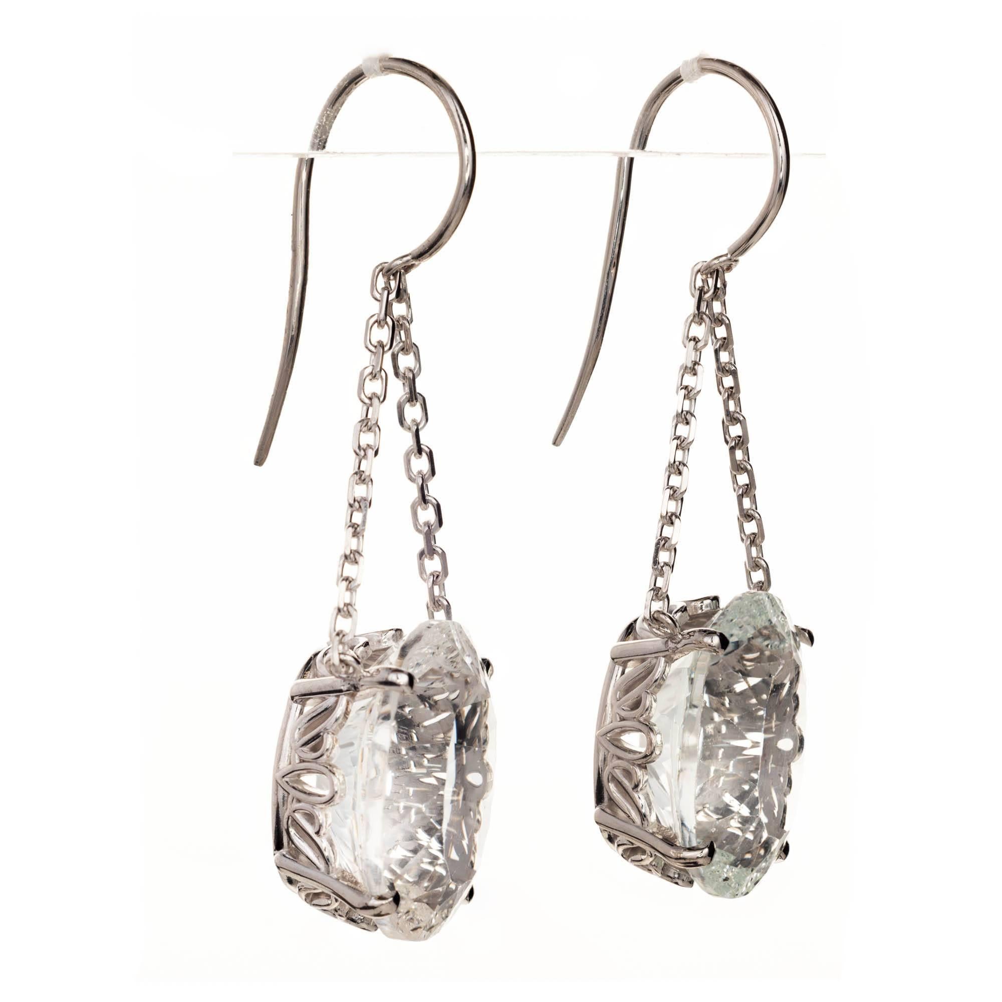 Two custom cut oval white 22.50 carat Topaz dangle earrings. 18 x 13mm each in custom white gold scroll settings, hung by a double 14k white gold cable chain from the Peter Suchy Workshop.

2 oval white Topaz 18 x 13mm, approx. total weight