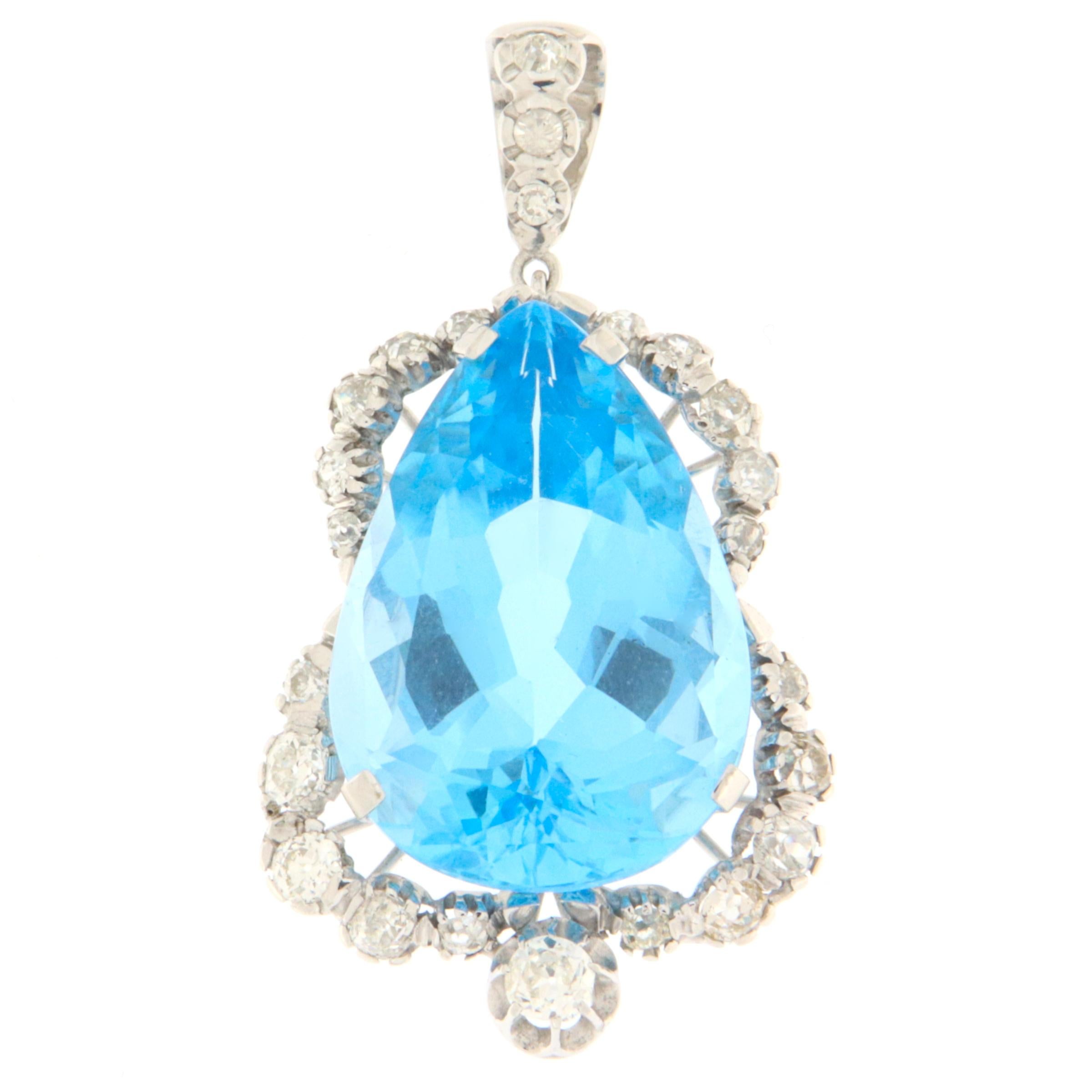 This elegant pendant in 18-karat white gold is a true embodiment of grace and splendor. At the heart of this creation lies a magnificent blue topaz, masterfully cut into a drop shape, capturing the essence of crystal-clear water and the endless sky.