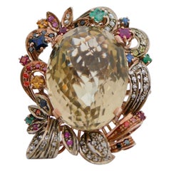 Topazio, smeraldi, rubini, zaffiri, diamanti, anello in oro rosa e argento.
