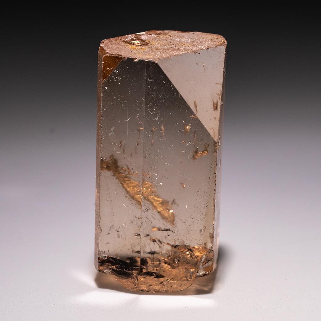 From Shigar Valley, Skardu, Baltistan, Gilgit-Baltistan, Pakistan Large single crystal of transparent sherry colored Topaz with sharp complex basal pinacoid terminations. Crystal is well formed with glassy luster faces. This topaz stands out with