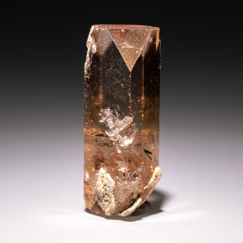 From Shigar Valley, Skardu, Baltistan, Gilgit-Baltistan, Pakistan Large single crystal of transparent sherry colored Topaz with sharp complex basal pinacoid terminations. Crystal is well formed with glassy luster faces. This topaz is known for its