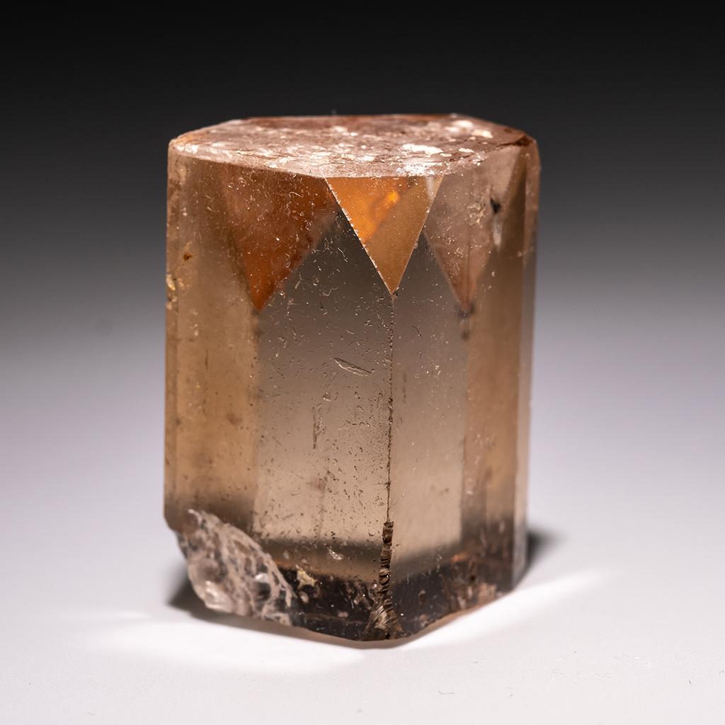 From Shigar Valley, Skardu, Baltistan, Gilgit-Baltistan, Pakistan Large single crystal of transparent sherry colored Topaz with sharp complex basal pinacoid terminations. Crystal is well formed with glassy luster faces. This variety of Topaz is