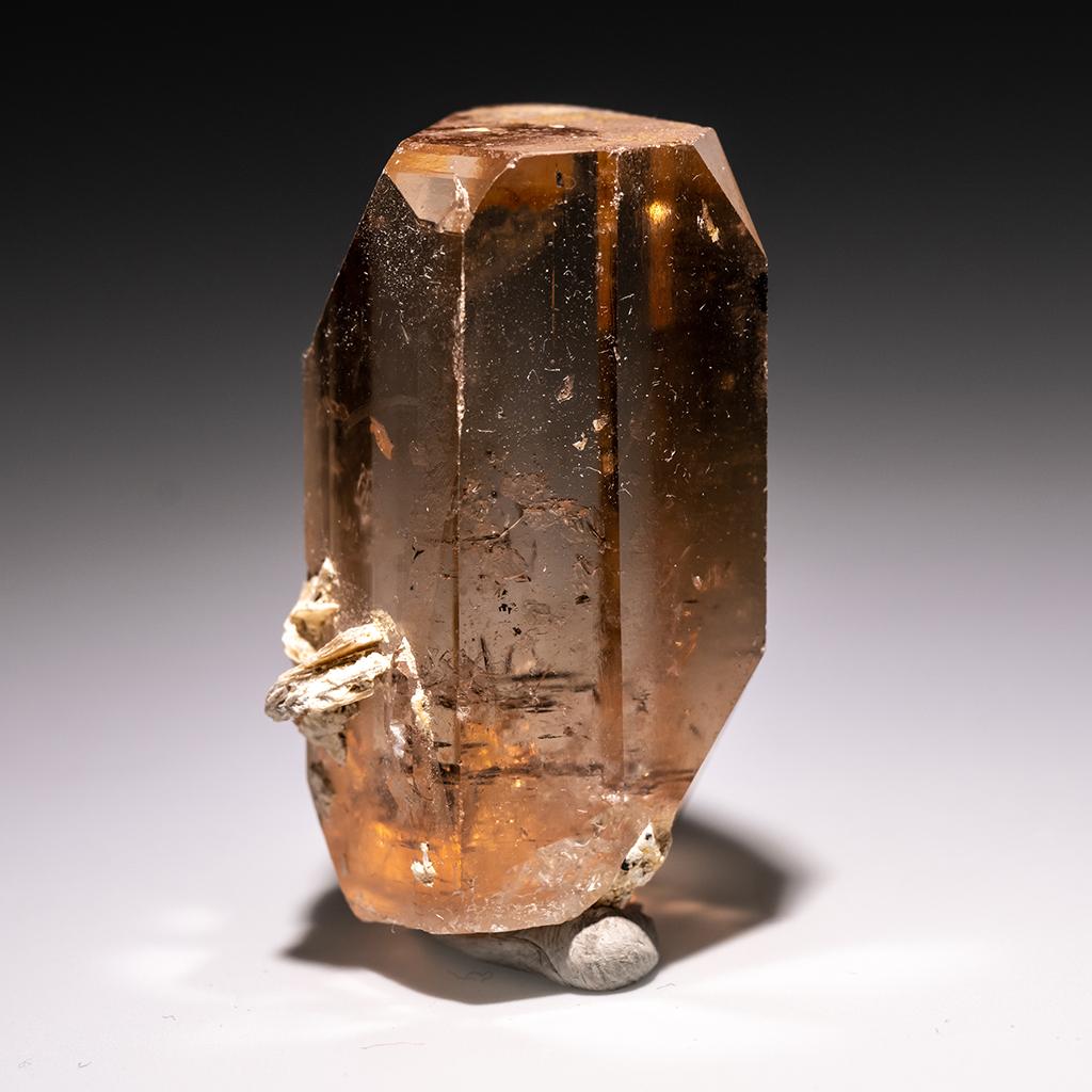 From Shigar Valley, Skardu, Baltistan, Gilgit-Baltistan, Pakistan Large single crystal of transparent sherry colored Topaz with sharp complex basal pinacoid terminations. Crystal is well formed with glassy luster faces. This 65.1 gram Topaz is an