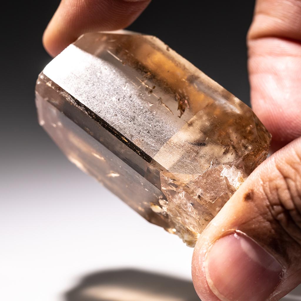 From Shigar Valley, Skardu, Baltistan, Gilgit-Baltistan, Pakistan

Large single crystal of transparent sherry colored Topaz with sharp complex basal pinacoid terminations. Crystal is well formed with glassy luster faces.

 Weight: 87.4 grams,