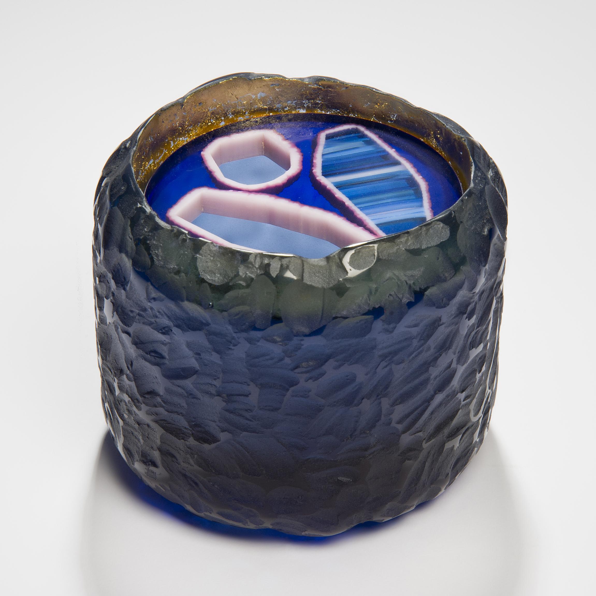 Topaz Murini Agate Jar is a unique blue, purple and pink sculptural / jar artwork created from cast glass by the British artist Angela Jarman. Using the lost wax technique, the base is cast blue lead crystal. The top disc insert is created from