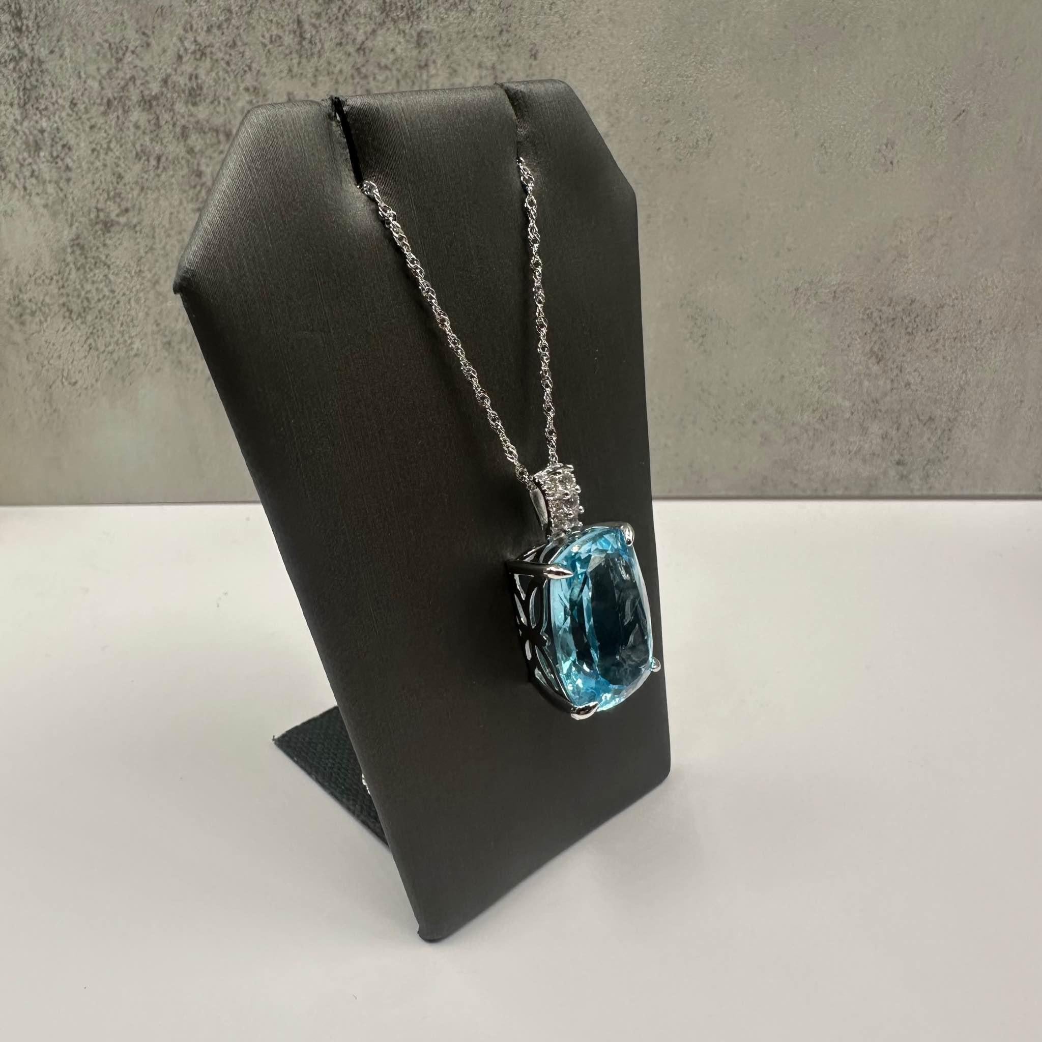This stunning Topaz Necklace in sterling silver features 23ctw of natural elongated blue topaz, creating a bold and vibrant focal point. The bail is set with 0.32ctw of natural white topaz, adding extra sparkle and contrast. Weighing 9.3 grams, this