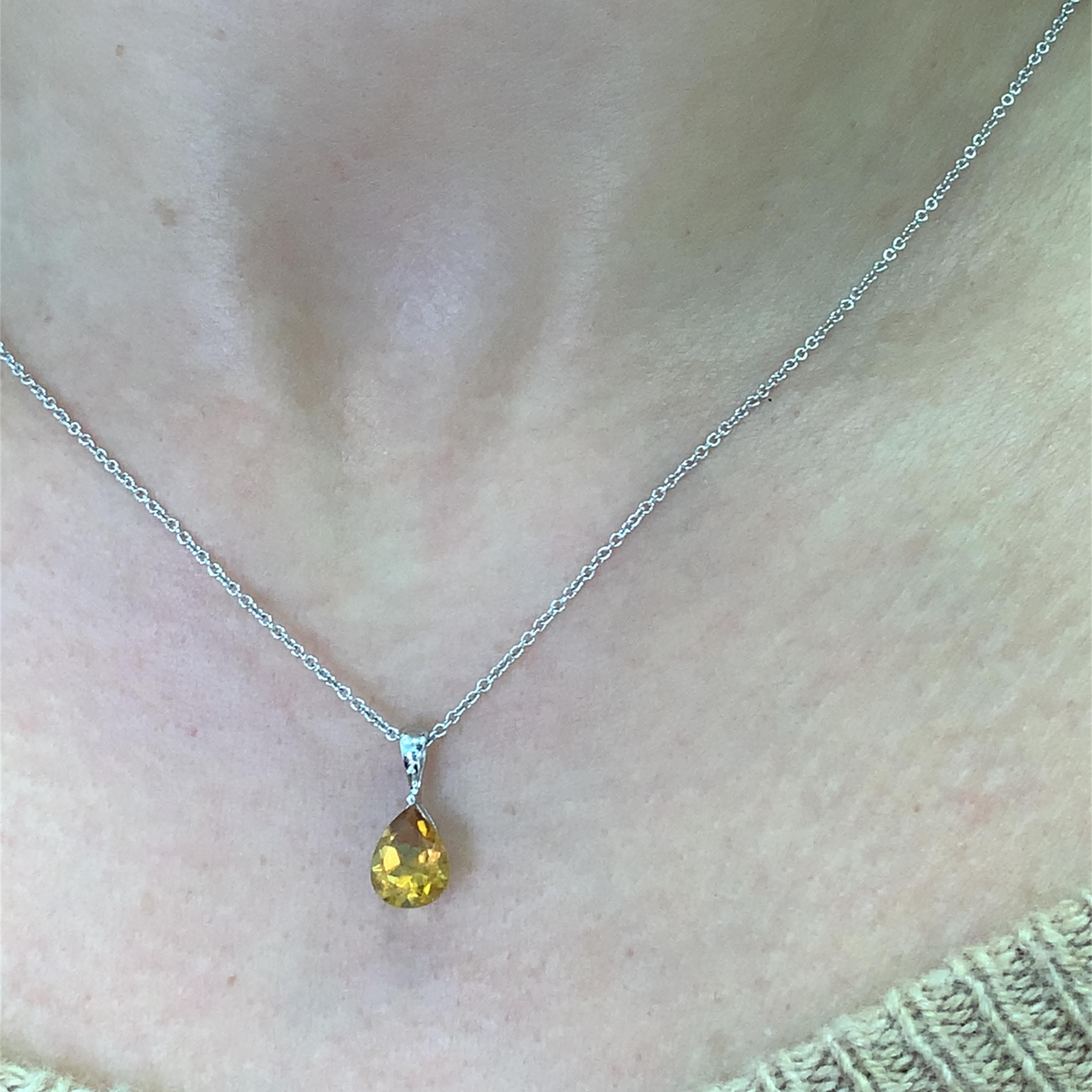 This stunning teardrop pendant necklace features a vibrant 1.50ct topaz orange gemstone that catches the light beautifully. Crafted in 18k white gold 18 inches length chain with precision, the delicate chain complements the pendant, making it a