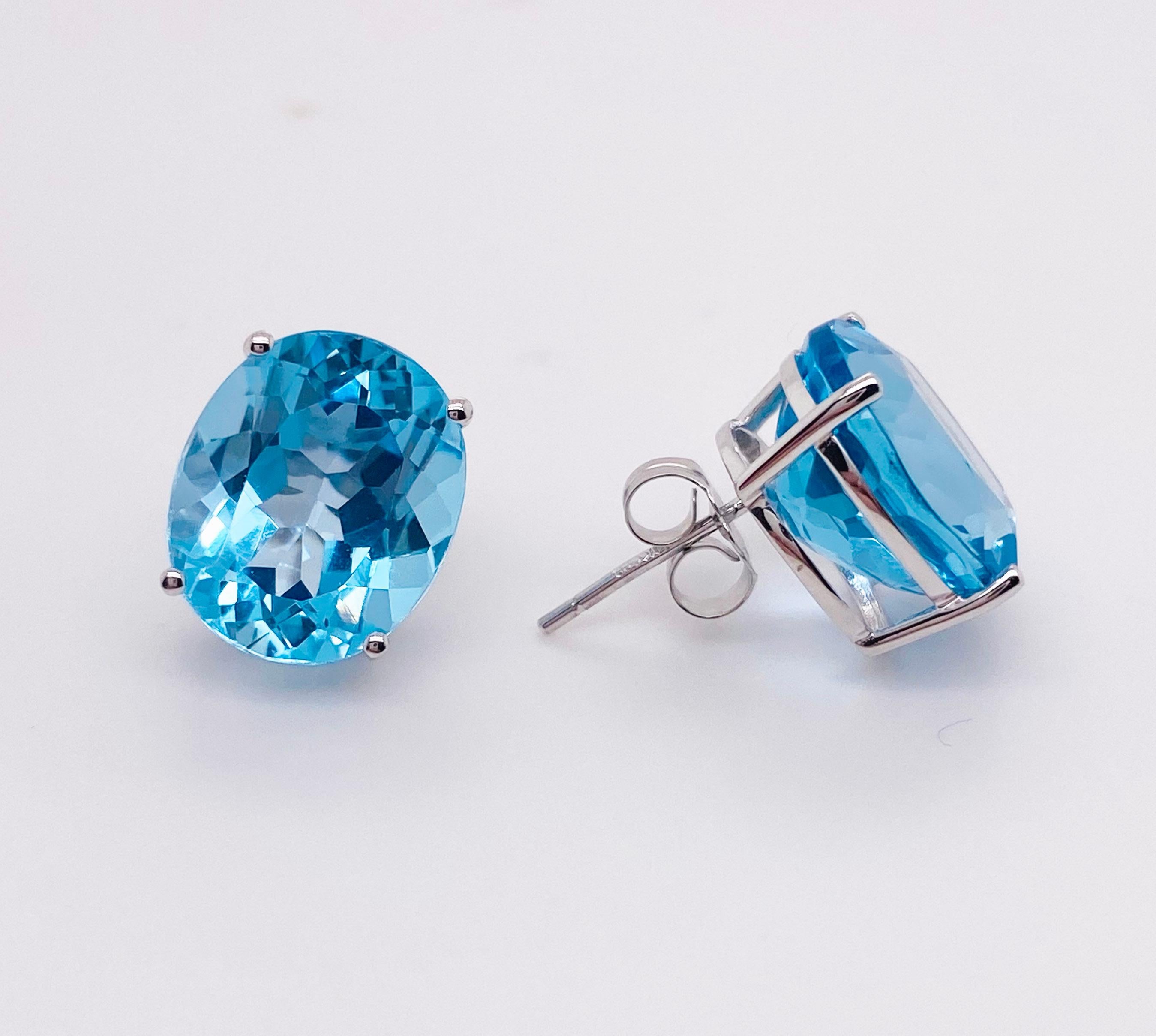 These oval Swiss blue topaz earrings are significant in size weighing 11.80 carats total weight! We pride ourselves in procuring the most beautiful blue topaz sourced ethically. These earrings make a great statement and the color blue looks good on