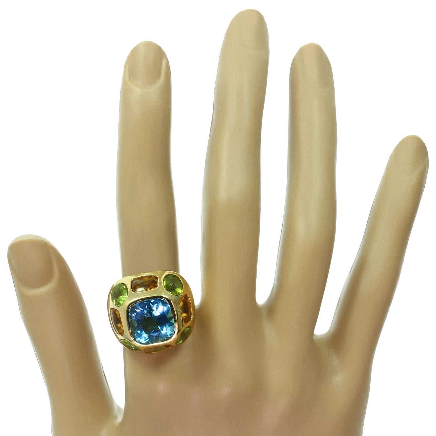 This gorgeous dome ring, Inspired by Chanel's Coco Baroque collection, is crafted in 18k yellow gold and set with a blue topaz center stone and peridot and citrine side stones. Made in United States circa 2000s. Measurements: 0.86