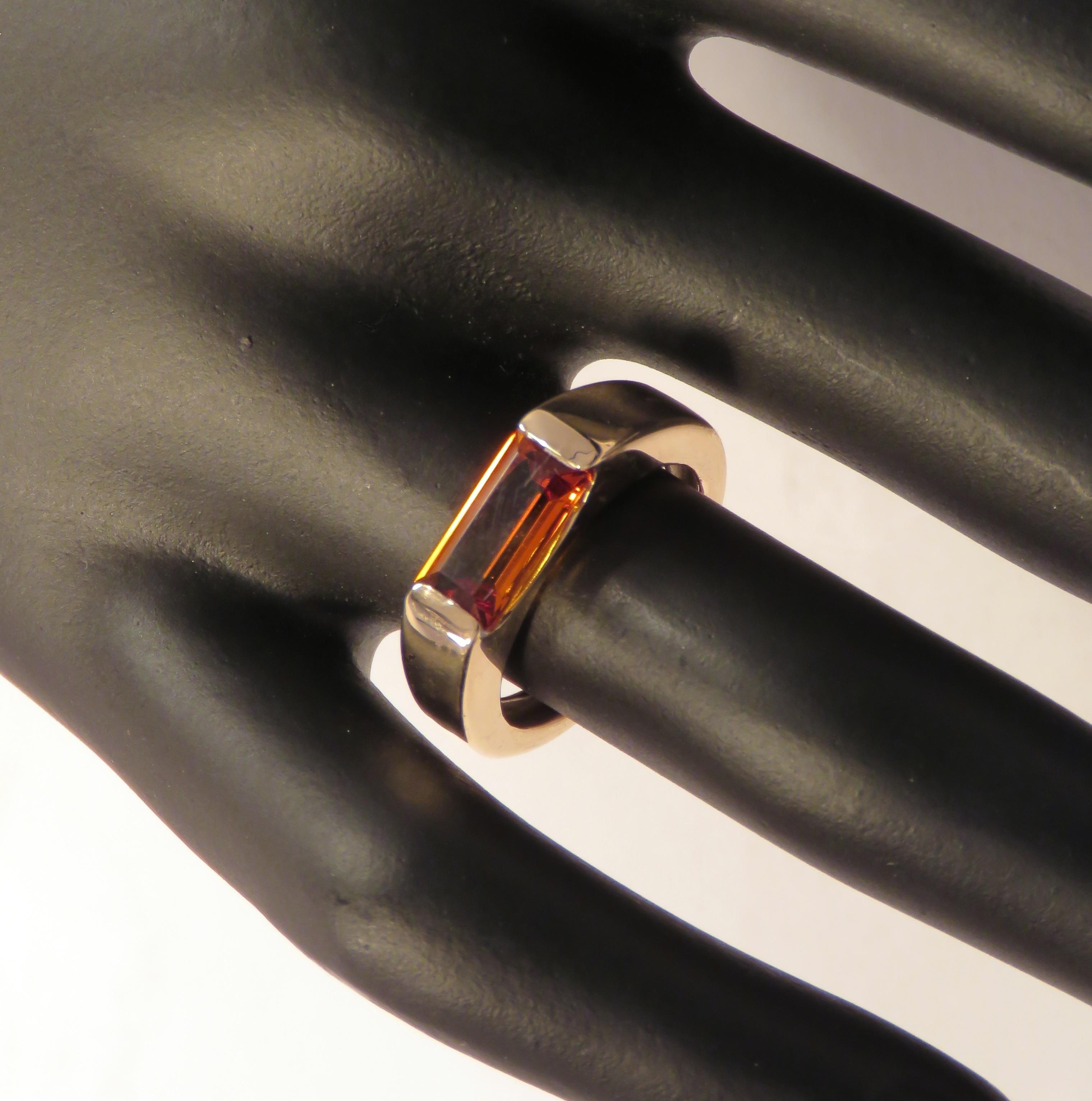 Very stylish modern band ring crafted in 9k rose gold featuring at the centre a baguette cut natural gold topaz weighing 1.5 ctw. The dimension of the gemstone is 10 x 5 millimeters / 0.393 x 0.196 inches. This ring is also available with baguette