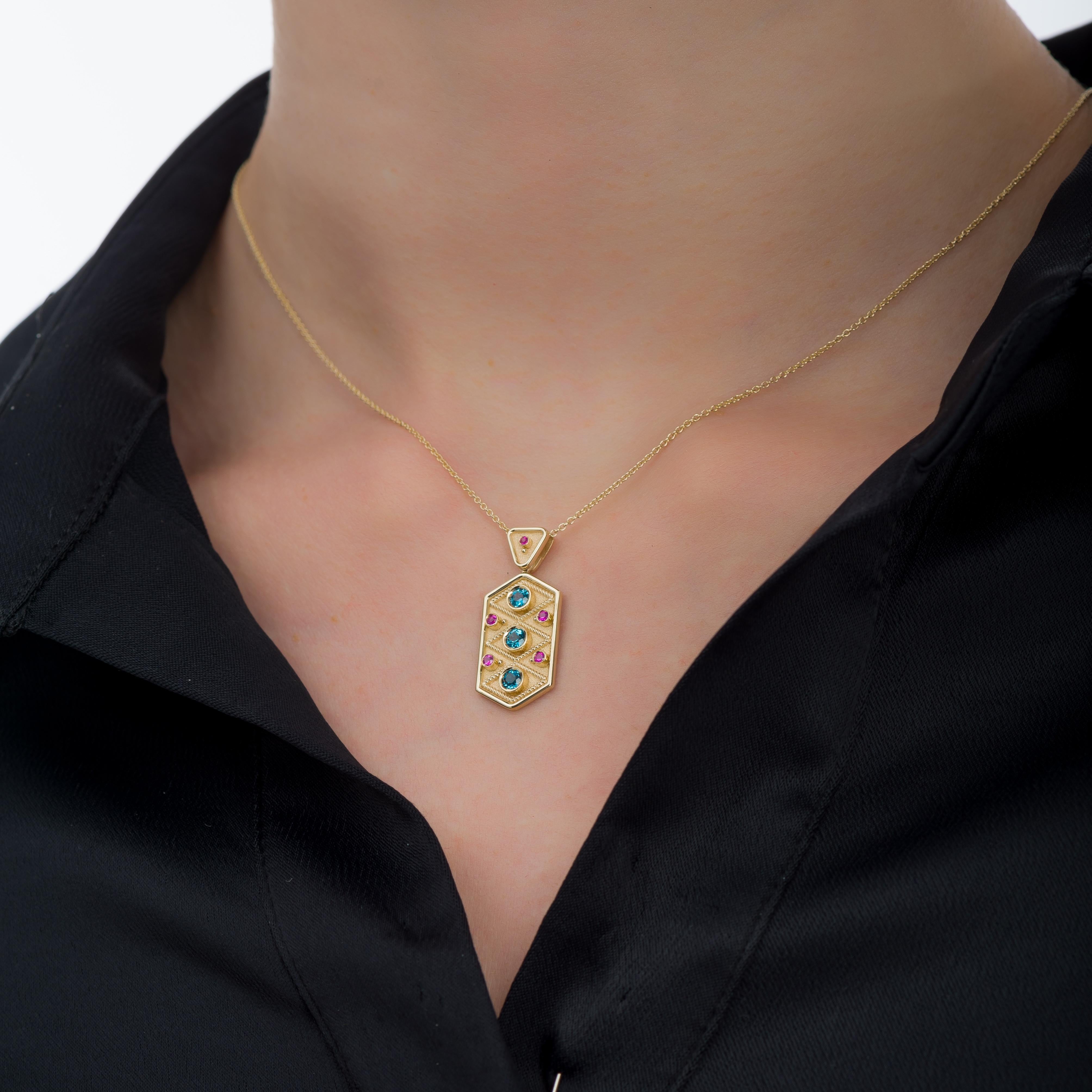 Our exceptional pendant draws inspiration from Byzantine aesthetics and the allure of ancient beauty, featuring topaz and sapphire stones that effortlessly elevate every look to a realm of exquisite sophistication.

100% handmade in our