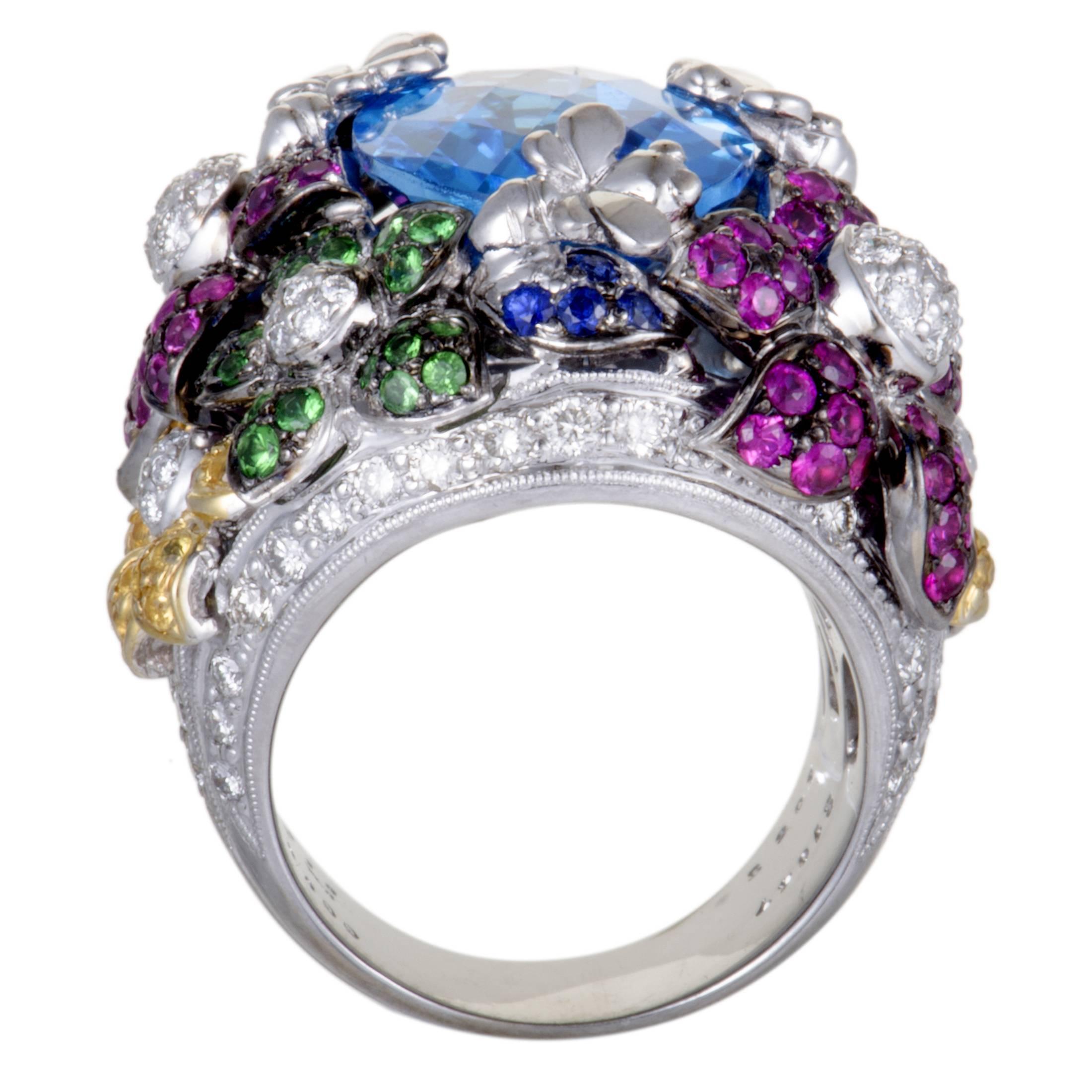 Spectacularly embellished in 1.18ct of sparkling diamonds, 10.55ct of exquisite garnets, 2.01ct of captivating sapphires and a magnificent topaz of 10.47ct , this sensational floral ring embodies glamour and splendor. Stunningly crafted in the