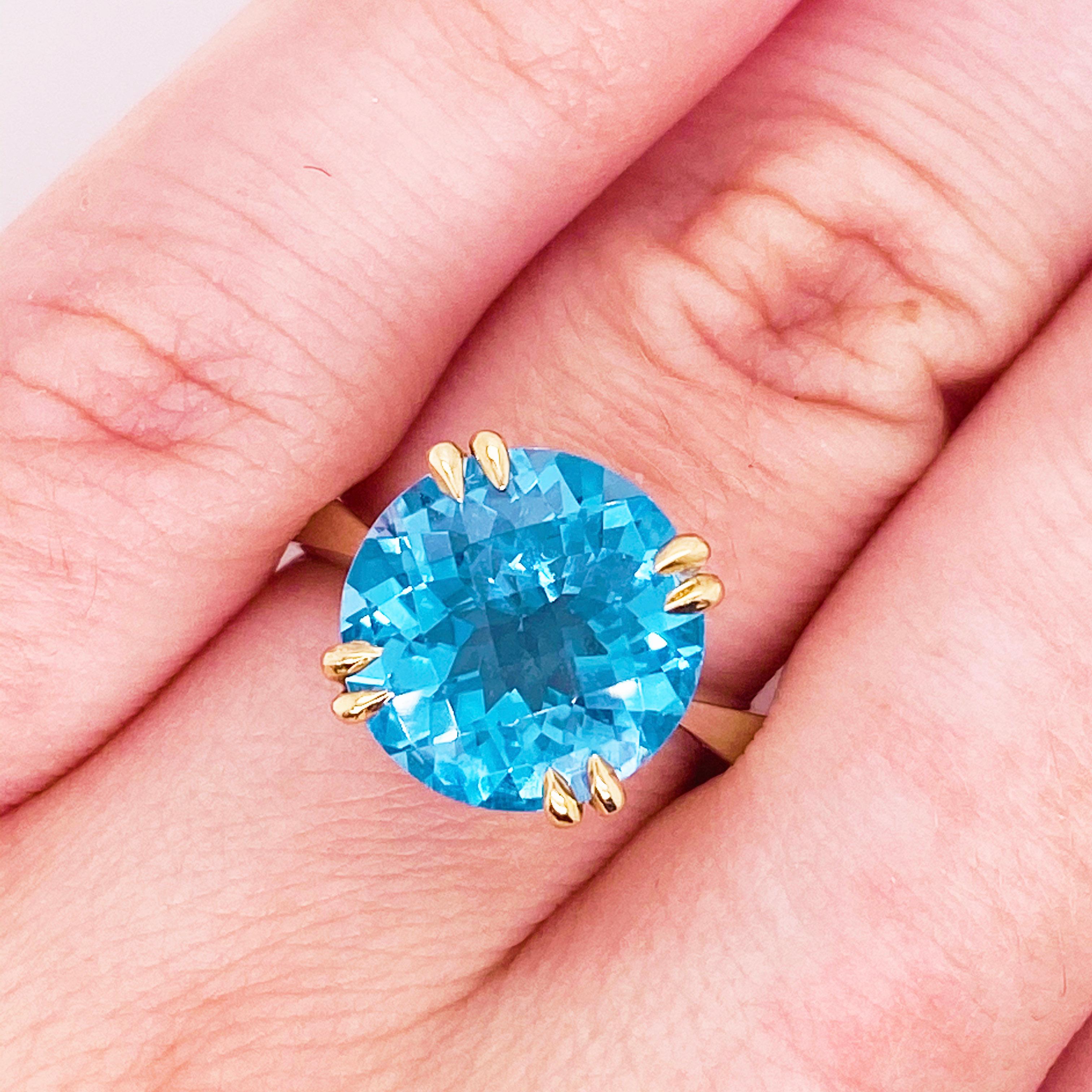These stunning bright blue topaz set in polished mixed metals of 14k yellow gold with a sterling band provides a look that is very classic and modern at the same time! This ring is very fashionable and can add a touch of style to any outfit, yet it