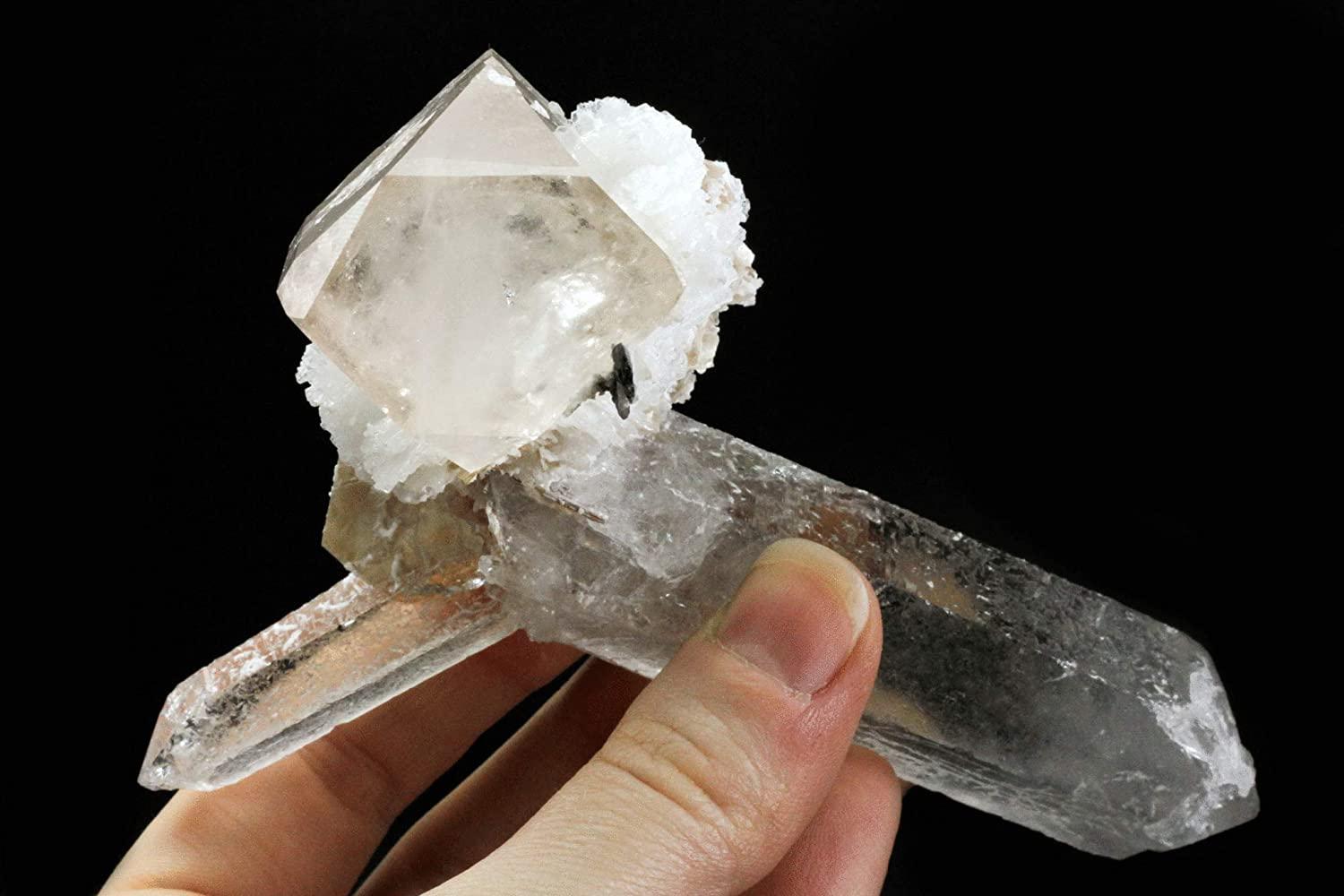 From Dassu, Braldu Valley, Skardu District, Baltistan, Gilgit-Baltistan, Pakistan

Large gem translucent topaz crystal with muscovite and albite perched on top 2 intersecting quartz crystals. The topaz has a faint champagne color with sharp