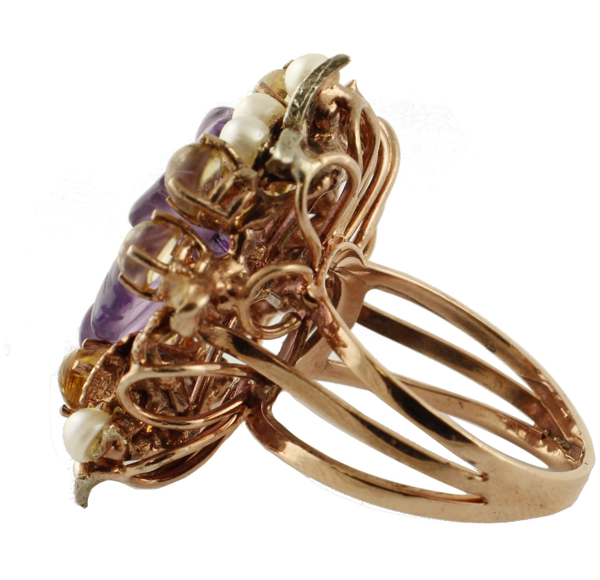 Beautiful ring in 9 kt rose gold and silver, 2.5 cm diameter, embellished with 2.46 ct olf yellow topazes, 1.4 g of amethyst flower, 0.07 ct of diamonds, 0.50 g of white little pearls. 
Diamonds ct 0.07
White Little Pearls g 0.50
Amethyst g