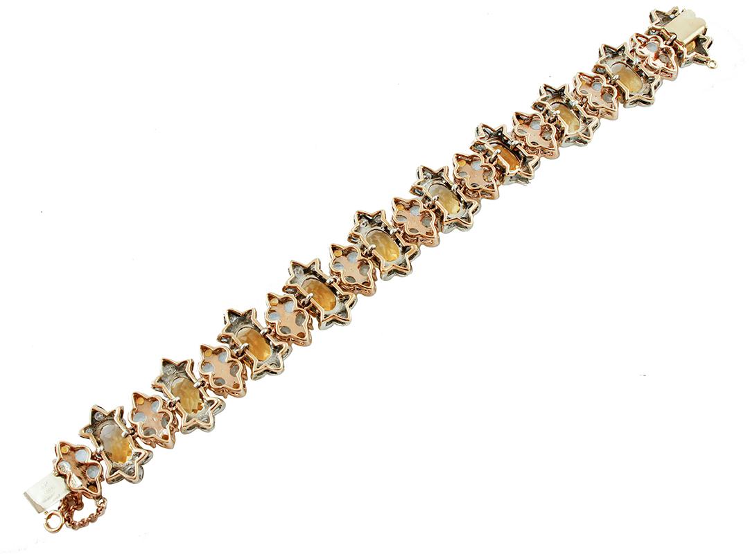 Vintage bracelet in 9k rose gold and silver structure, mounted with yellow topaz sections, which alternate with aquamarine little flowers and decorations of diamonds.
The origin of this bracelet goes probably back to the 1980s, it was totally