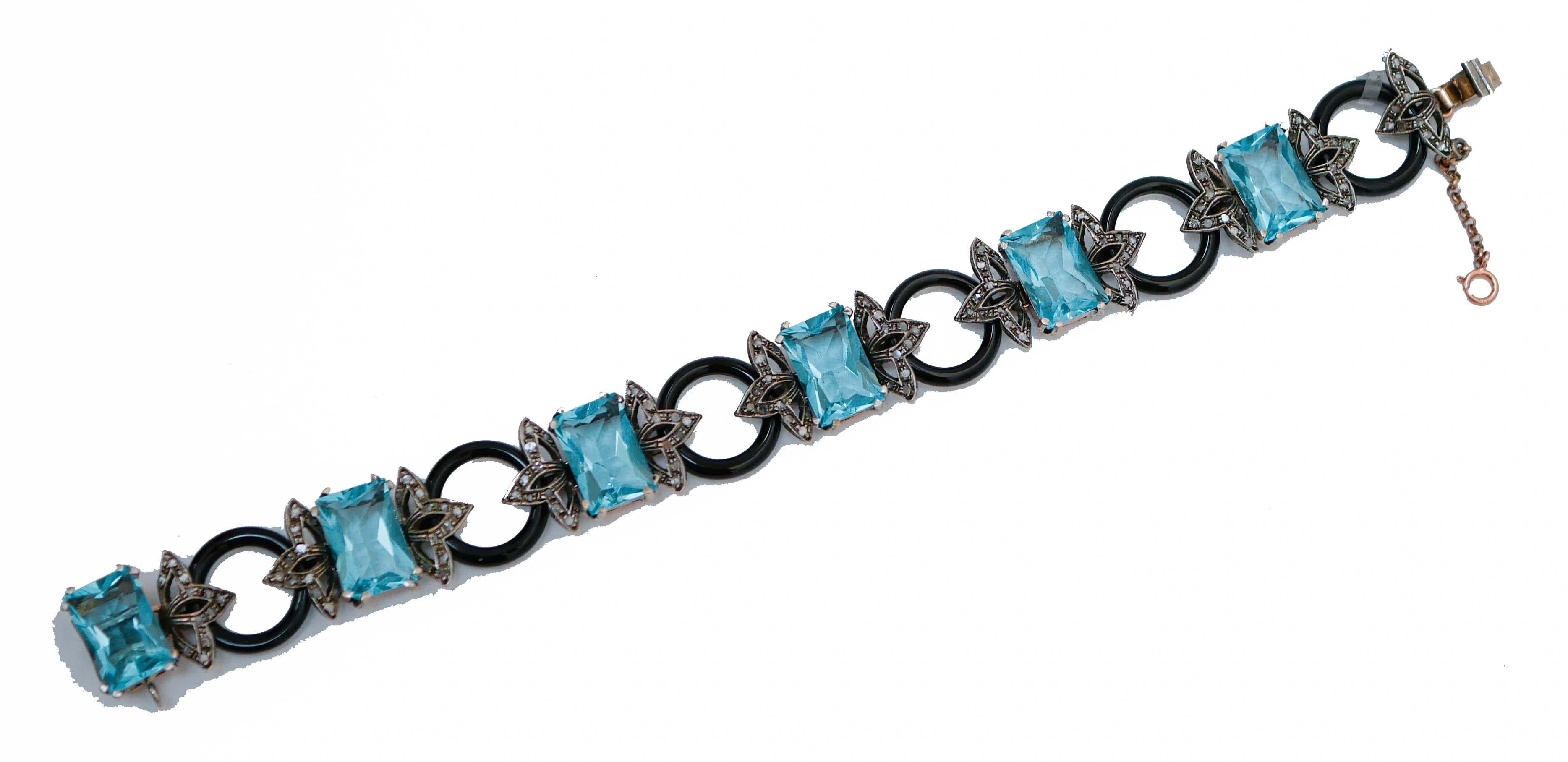 Bracciale Retrò in oro rosa 9 kt e struttura in argento montata con sezioni di topazio con foglie tempestate di diamanti collegate a dischi di onice.
Questo bracciale è stato realizzato completamente a mano da maestri orafi italiani ed è in perfette