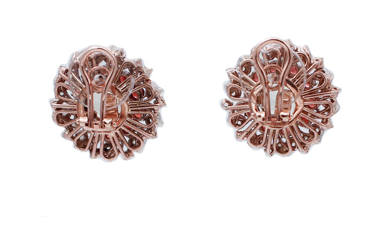 Beautiful retrò earrings in 9 karat rose gold and silver structure mounted with a round topaz ( diameter of 11 mm ) in the central part,surrounded by diamonds,garnets and topazs.
These earrings were totally handmade by Italian master goldsmiths and